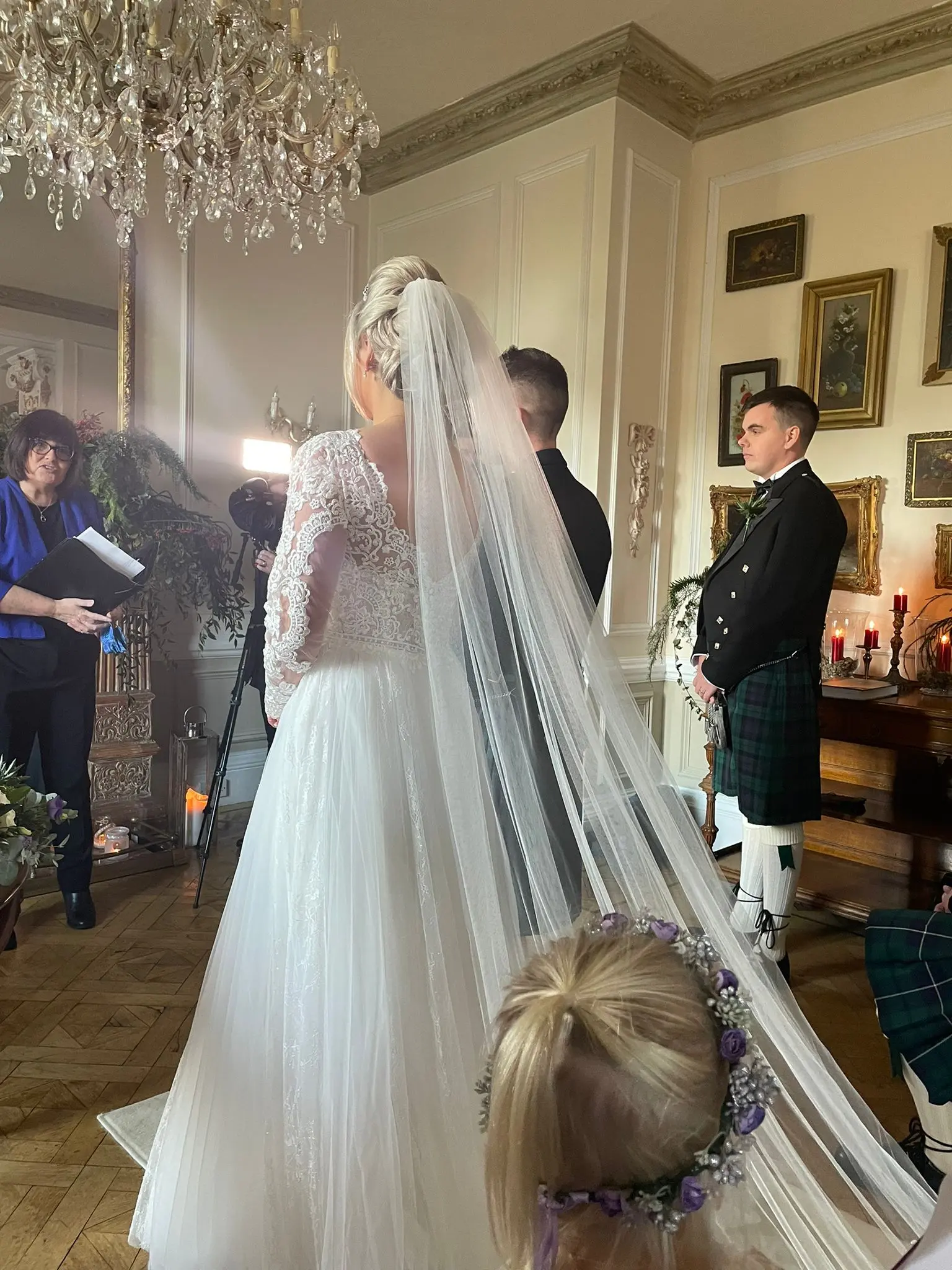 Bride Wearing Chic Lace Wedding Dress Called Iris By Rebecca Ingram and Groom In The Wedding Ceremony