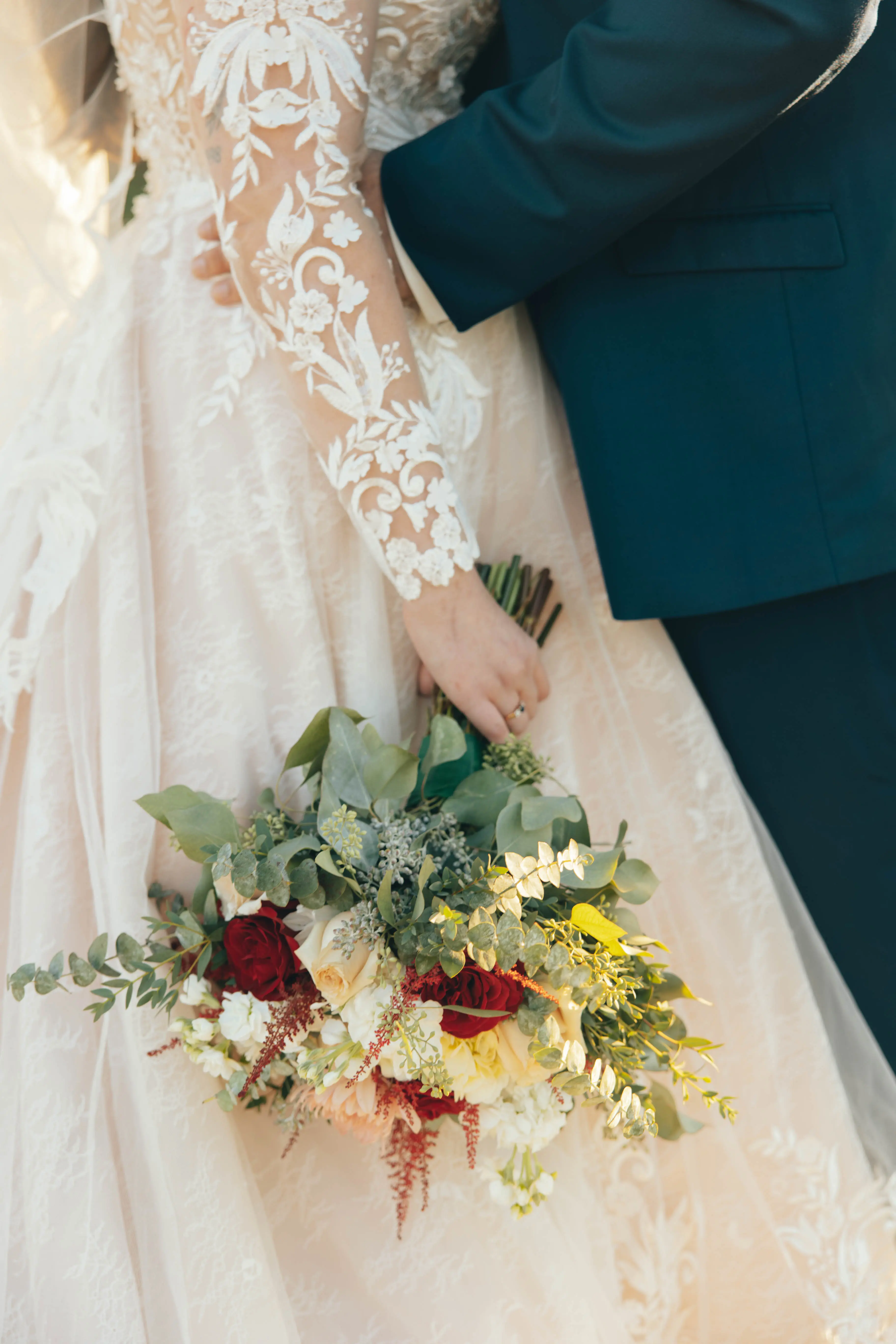Bride wearing Zander wedding gown by Sottero and Midgley holding her bouquet
