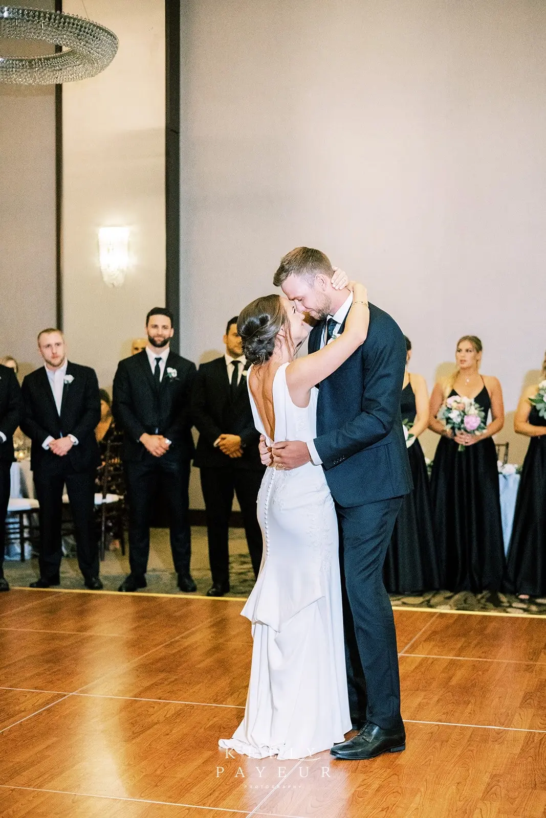 Bride wearing simple crepe wedding dress Bertina by Maggie Sottero.