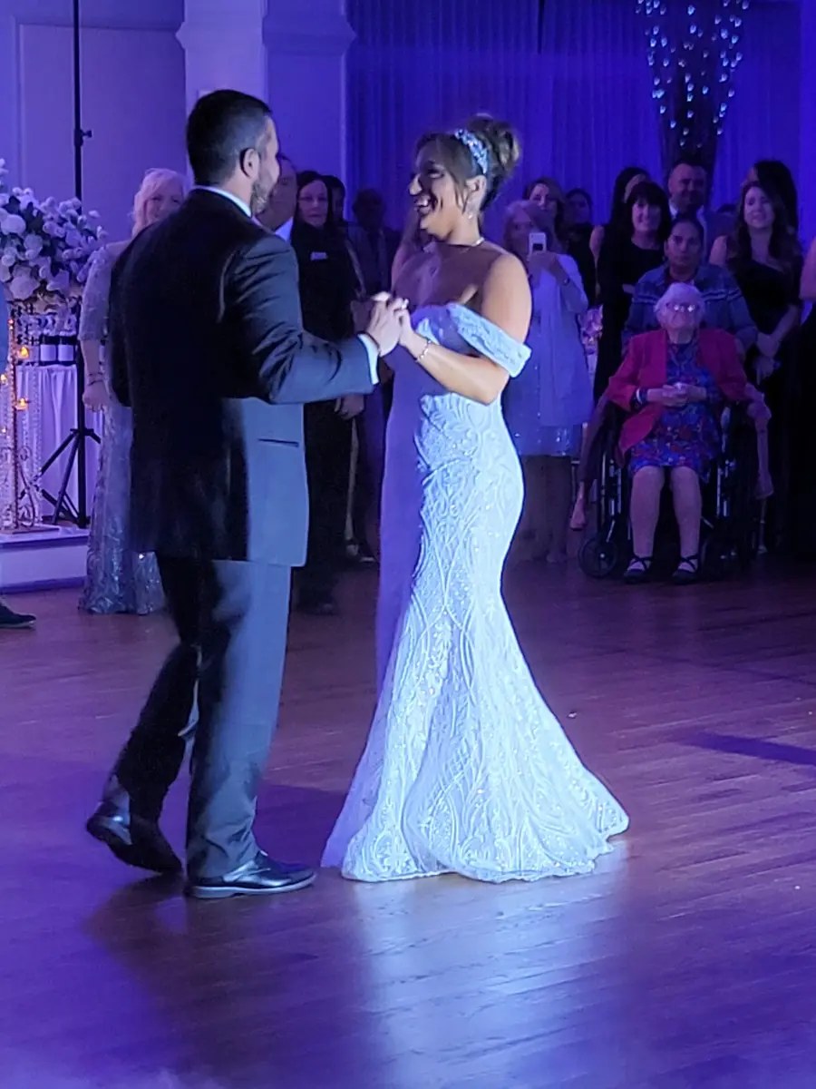 Bride wearing Bronson wedding dress by Sottero and Midgley dancing with her husband