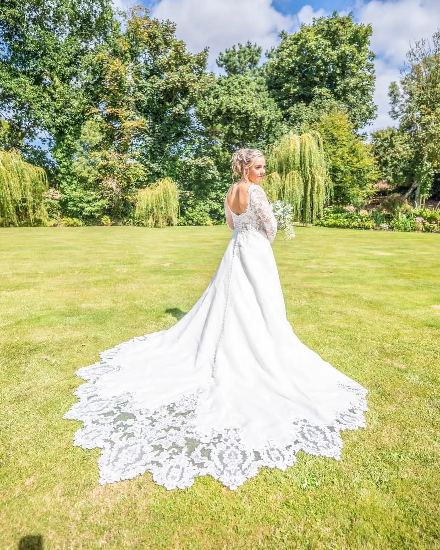 Bride In A-Line Wedding Dress Named Savannah By Maggie Sottero Bride Posing In Nature