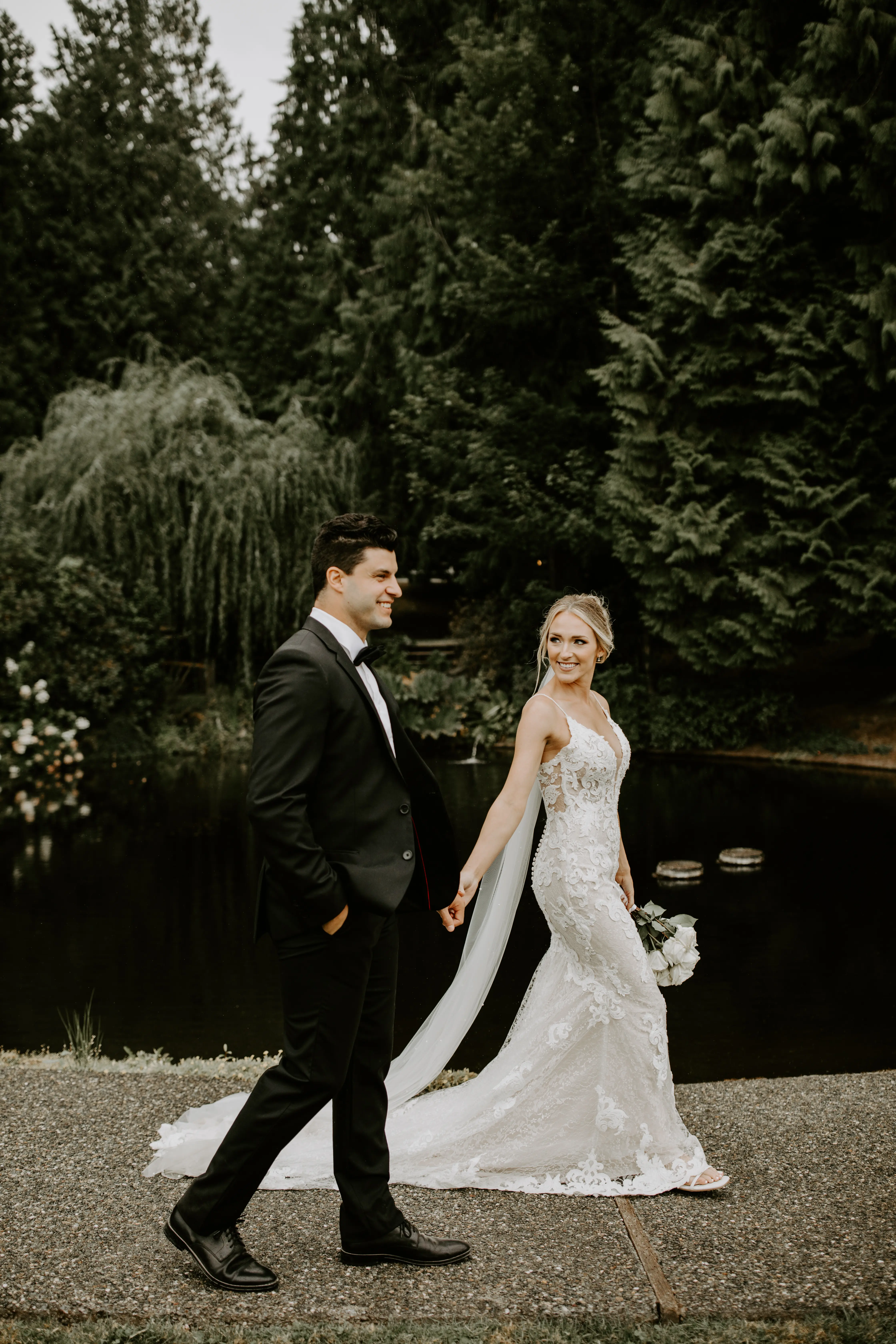 Bride with groom wearing romantic lace sheath wedding dress