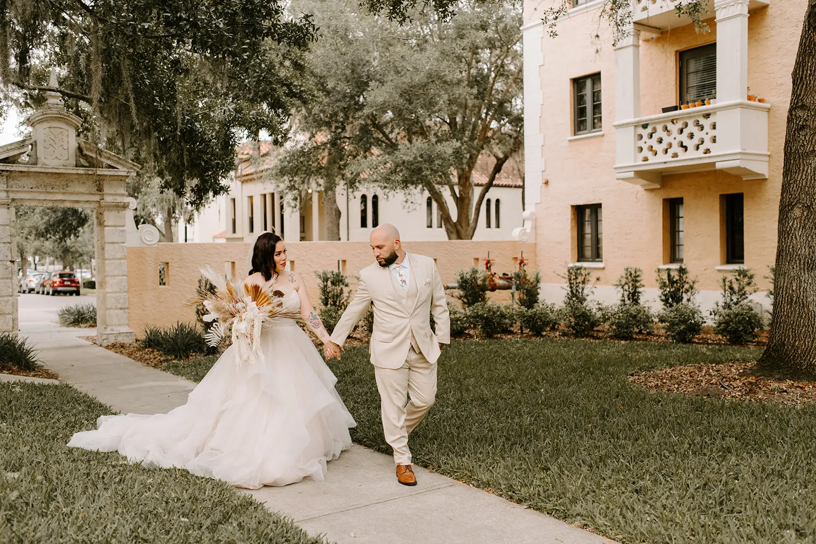 Bride with groom wearing strapless tulle ballgown wedding dress