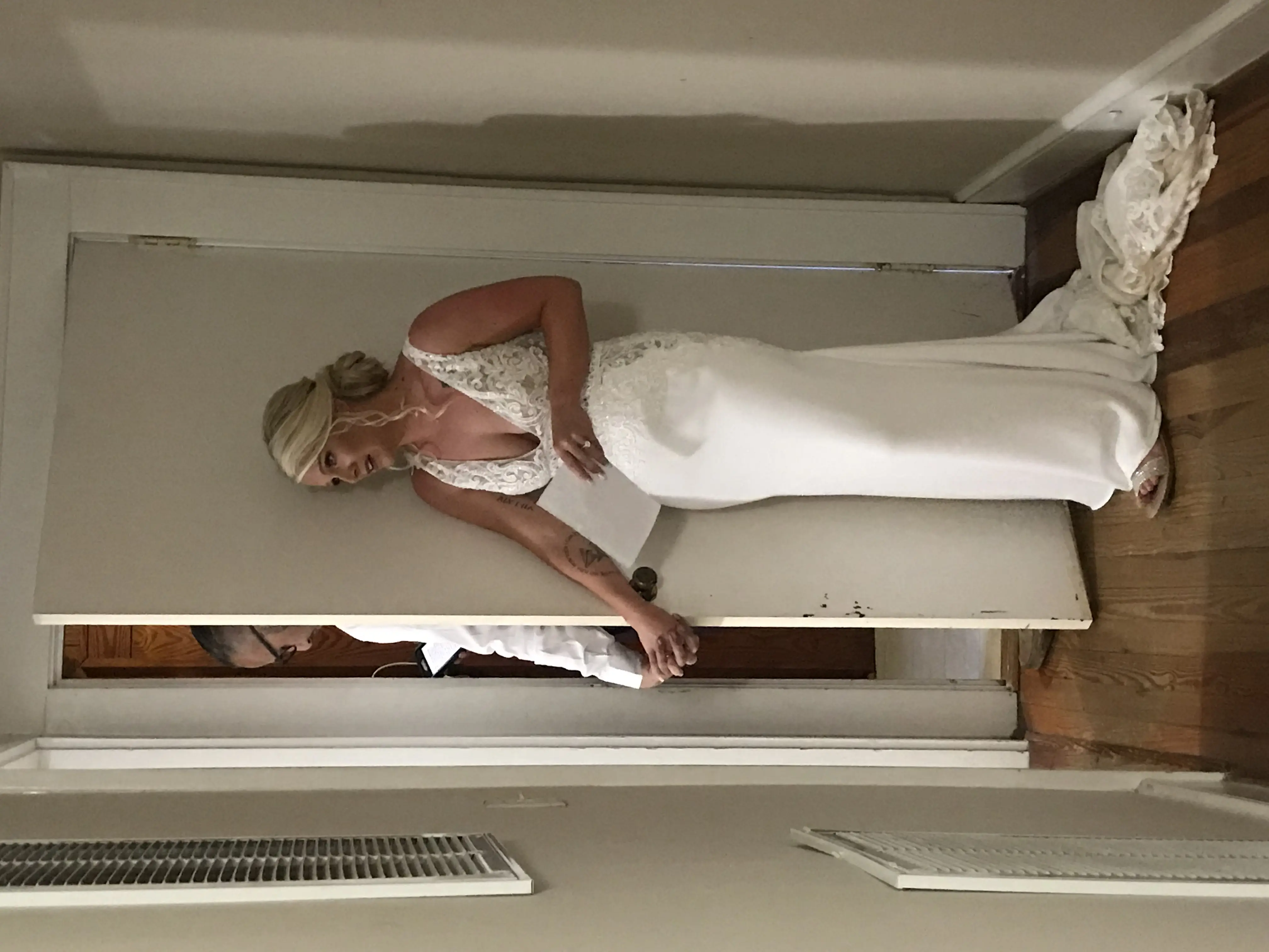 Groom and Bride Sharing Notes before the Ceremony Wearing Aidan Lace Sheath Bridal Dress Called Aidan By Maggie Sottero