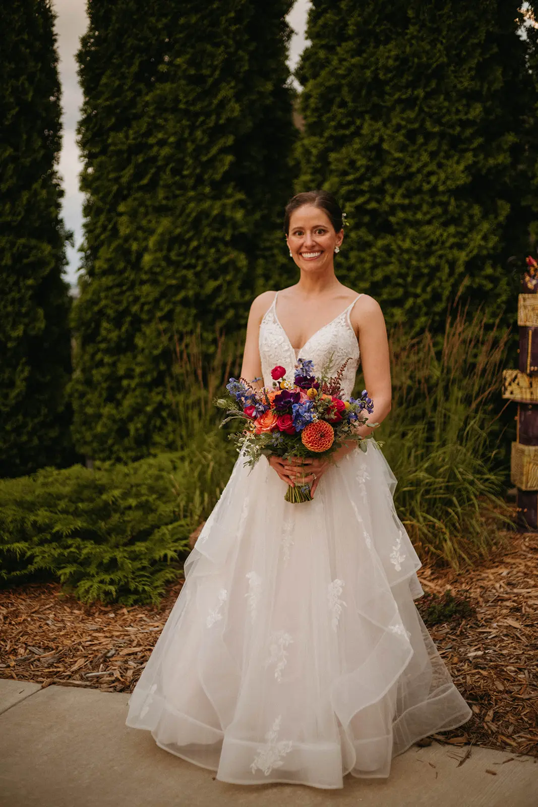 Bride In Floral Lace Bridal Gown Named Lettie By Rebecca Ingram Bride Holding Flowers