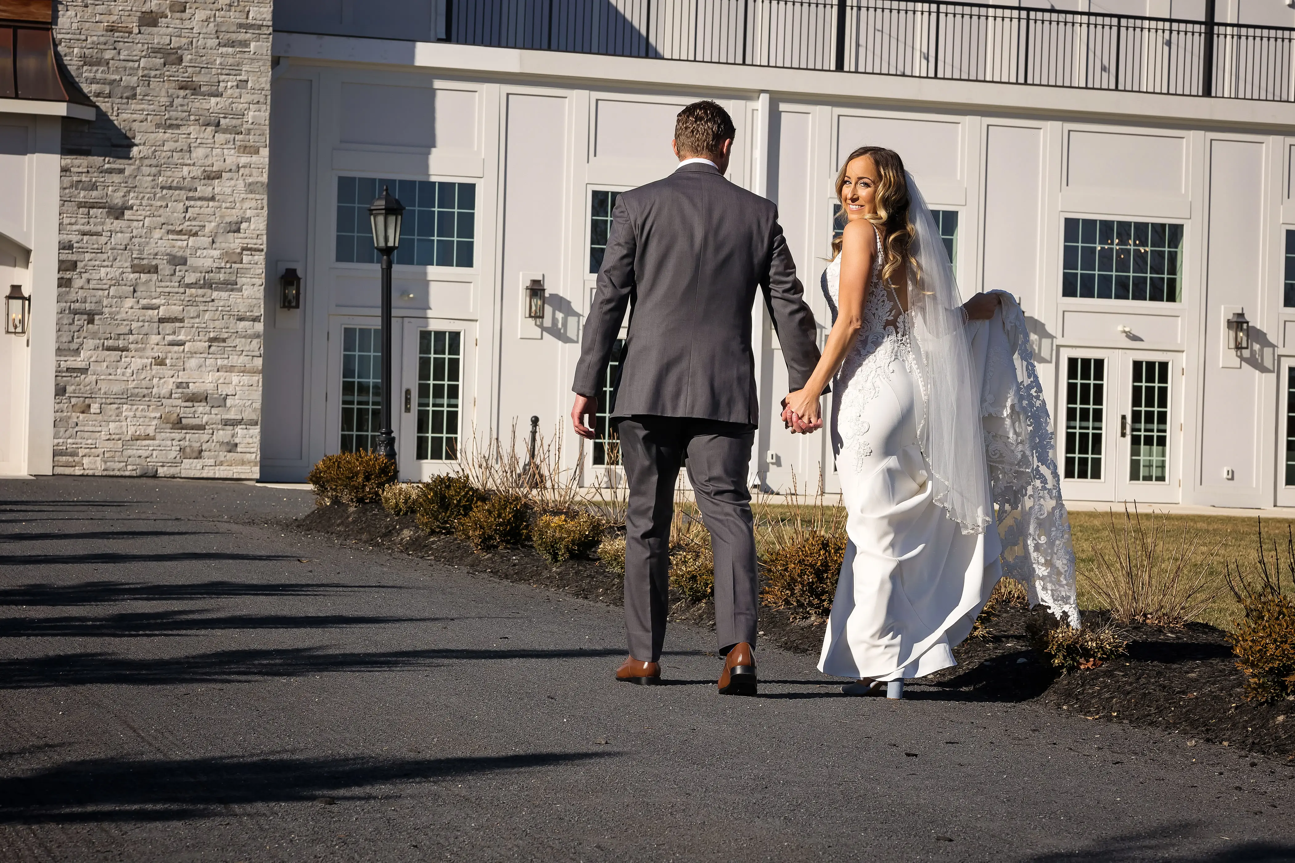 Bride Wearing Lace Mermaid Wedding Gown Called Nikki By Maggie Sottero Walking With Groom