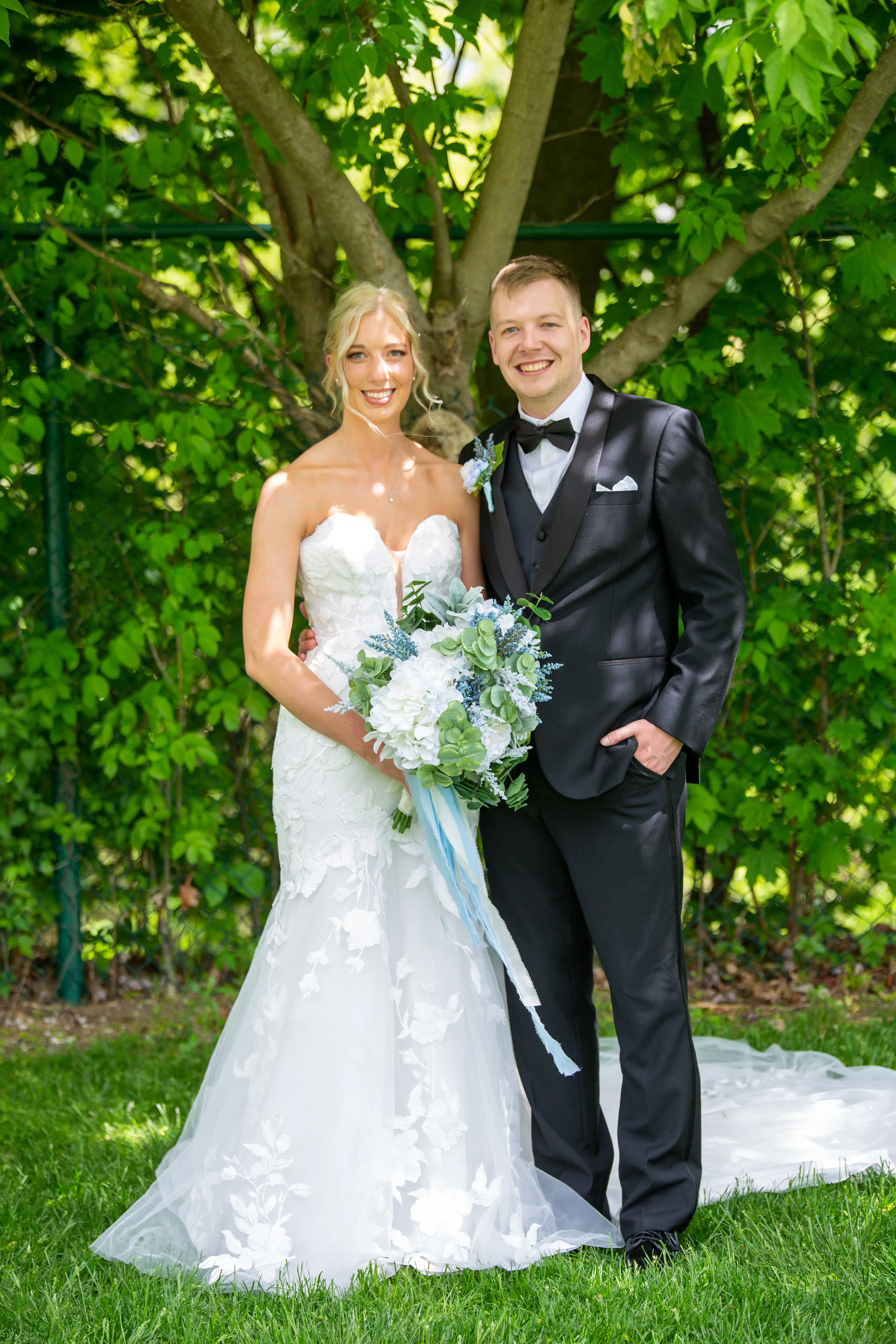 Groom with Real Bride in Strapless Mermaid Bridal Gown with Oversized Floral Lace Motifs over Sparkle Tulle called Hattie by Rebecca Ingram