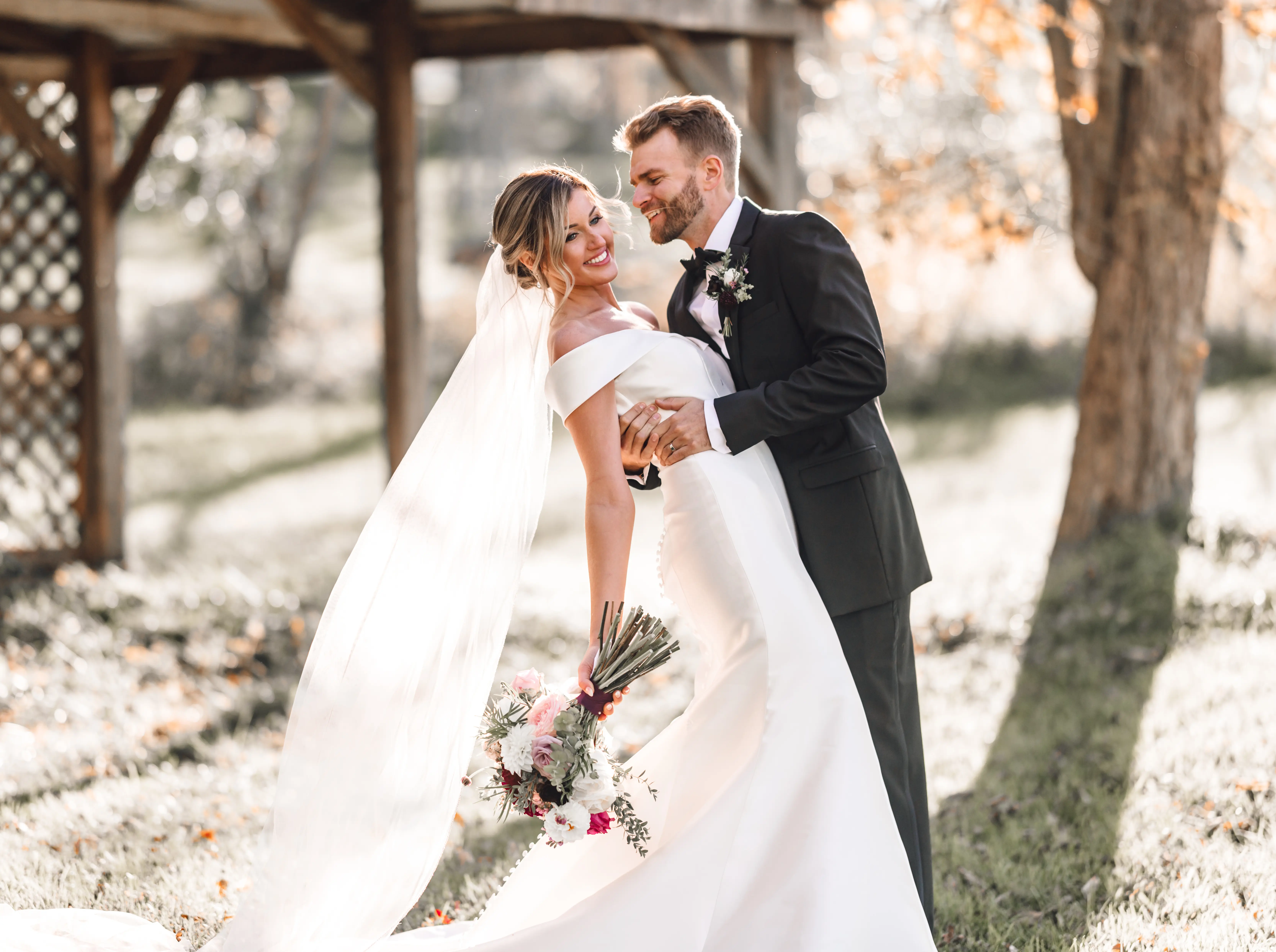 Groom With Bride In Off The Shoulder Mikado Wedding Dress Named Josie By Rebecca Ingram