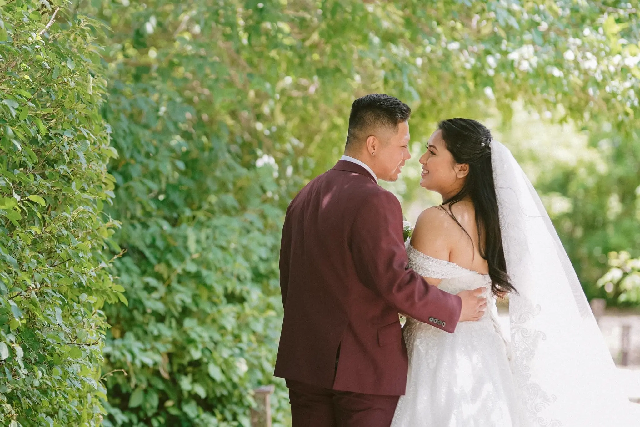 Back view of bride and groom looking into each other's eyes.