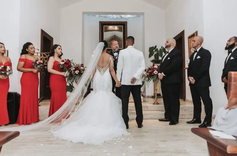 Bride with groom wearing glamorous mermaid wedding dress