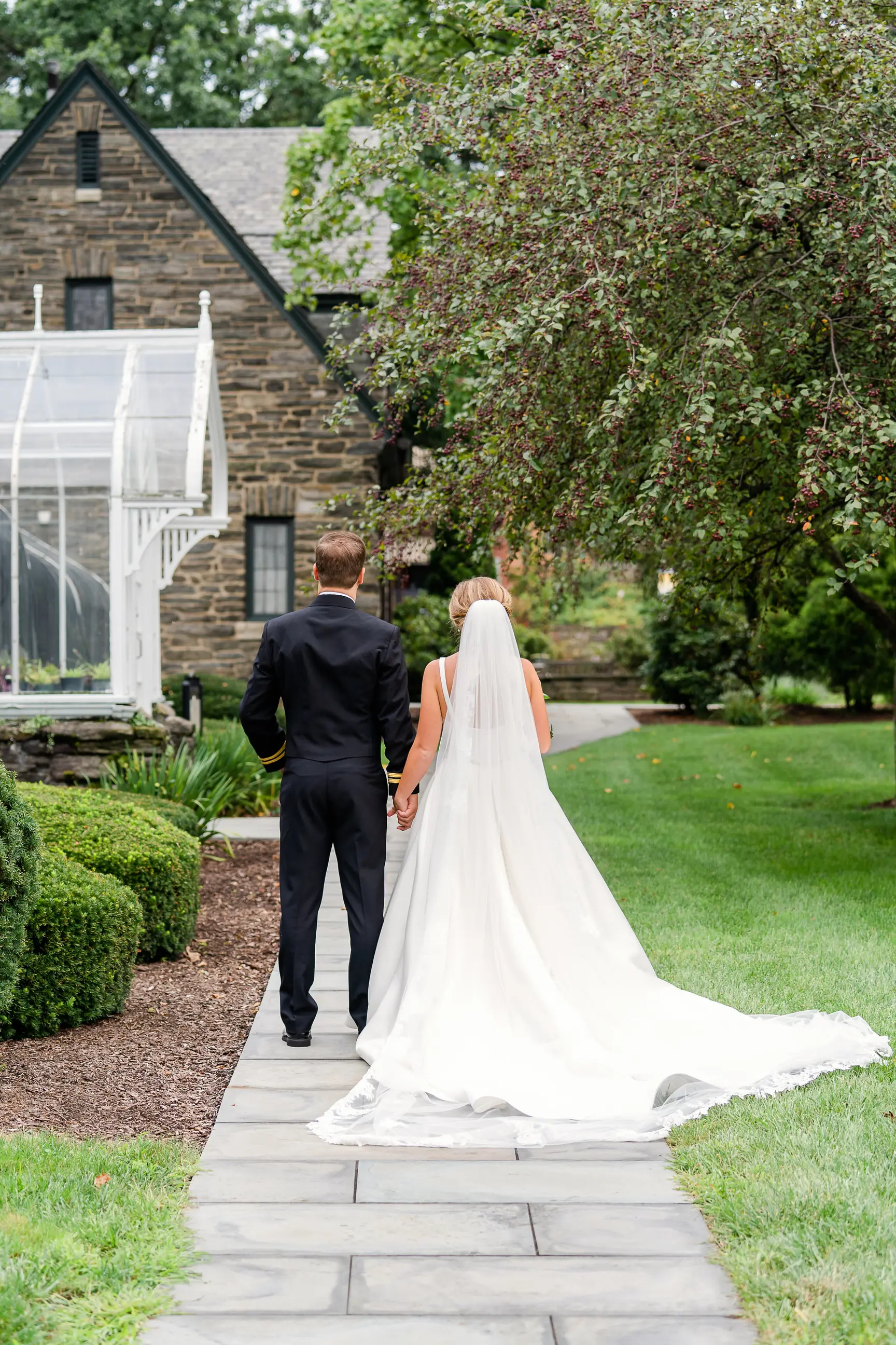 Bride wearing Simple Ballgown Wedding Dress called Selena by Maggie Sottero walking away with the groom