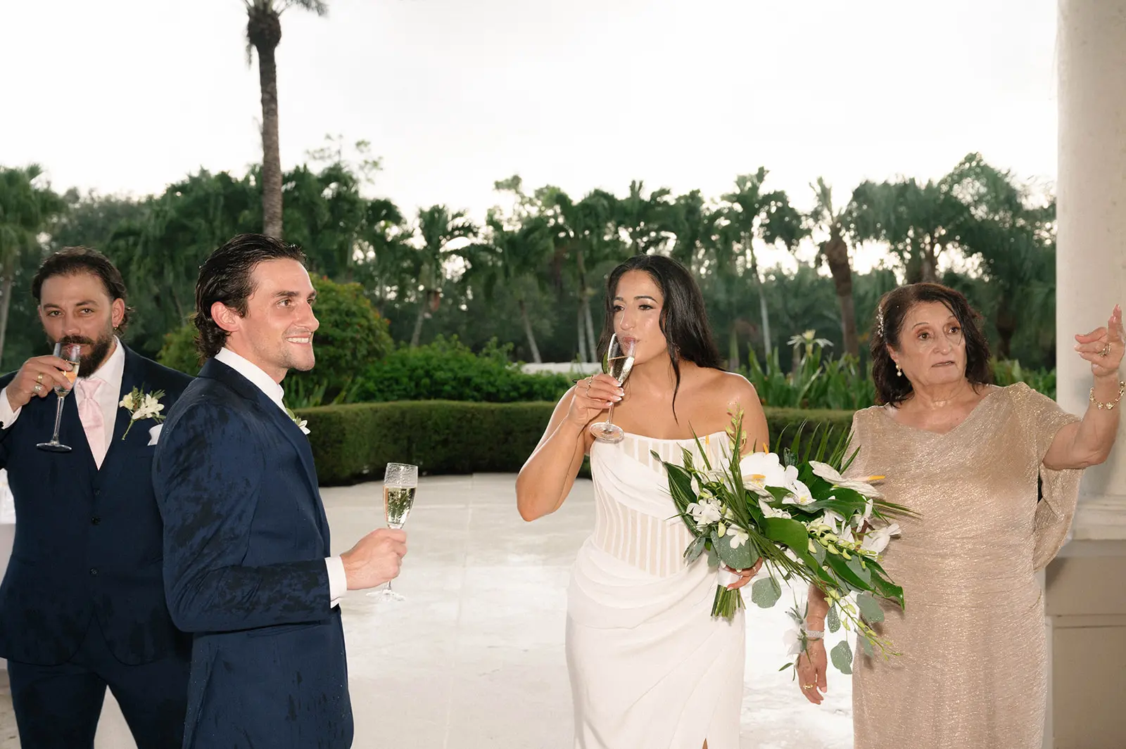 Bride Wearing Grecian Inspired Wedding Dress Called Gabrielle By Maggie Sottero Drinking Champagne