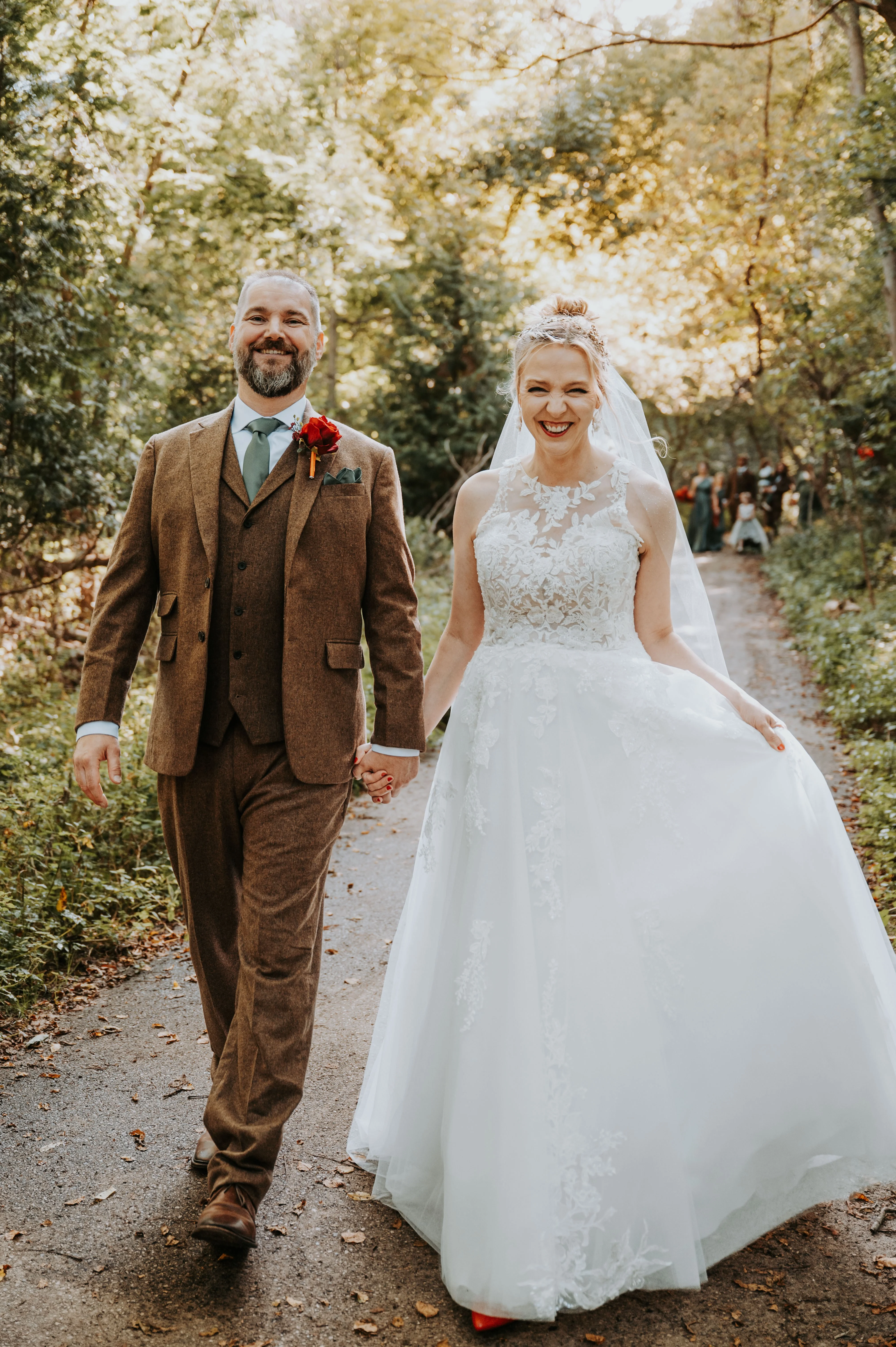 Bride wearing Lace Aline Wedding Dress Called Rickie By Rebecca Ingram Walking With Groom