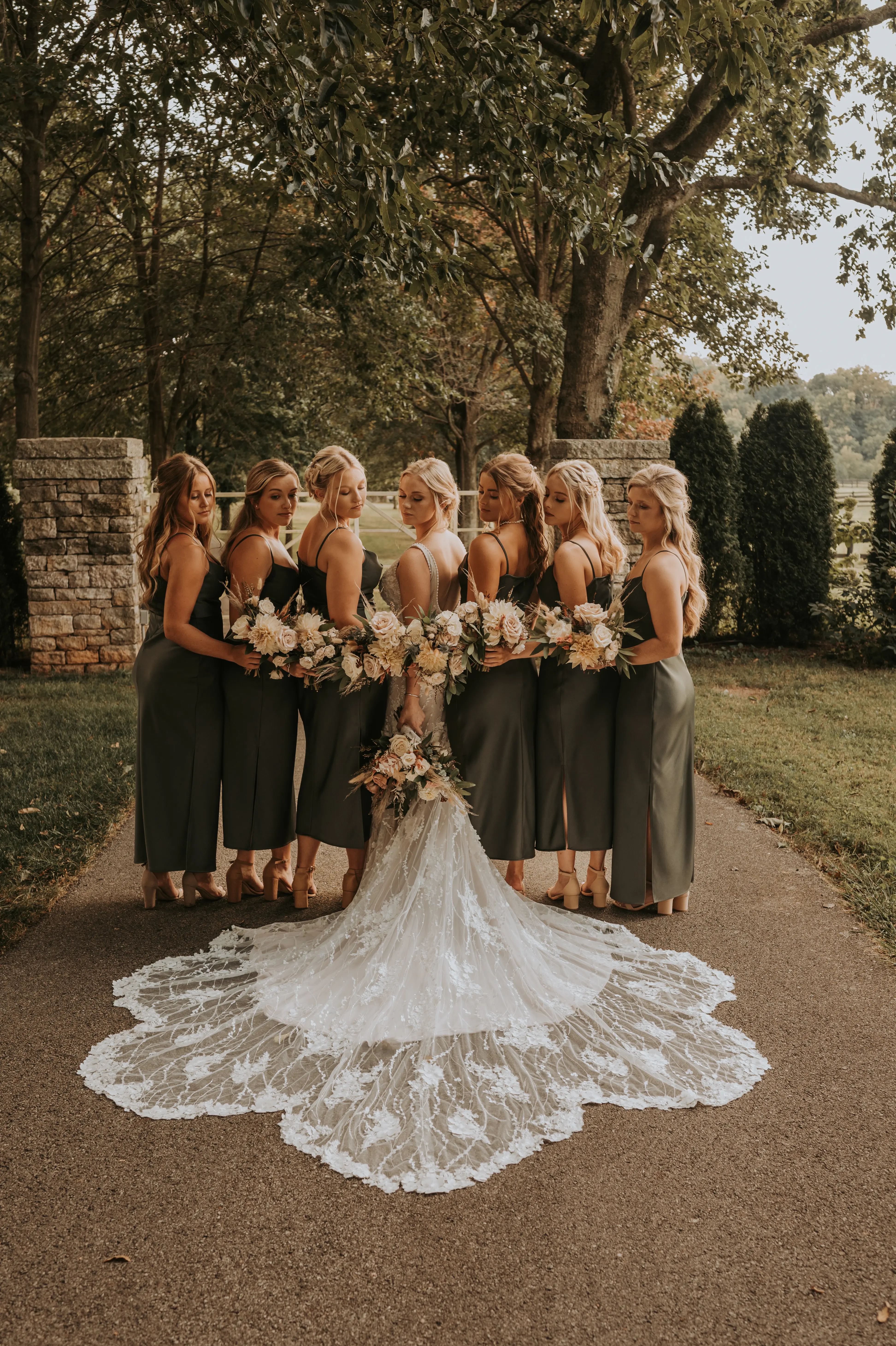 Bridal Party with Bride in Mermaid Wedding Dress with 3-D Floral Motifs and Extended Scalloped Lace Train Called Cruz by Sottero & Midgley