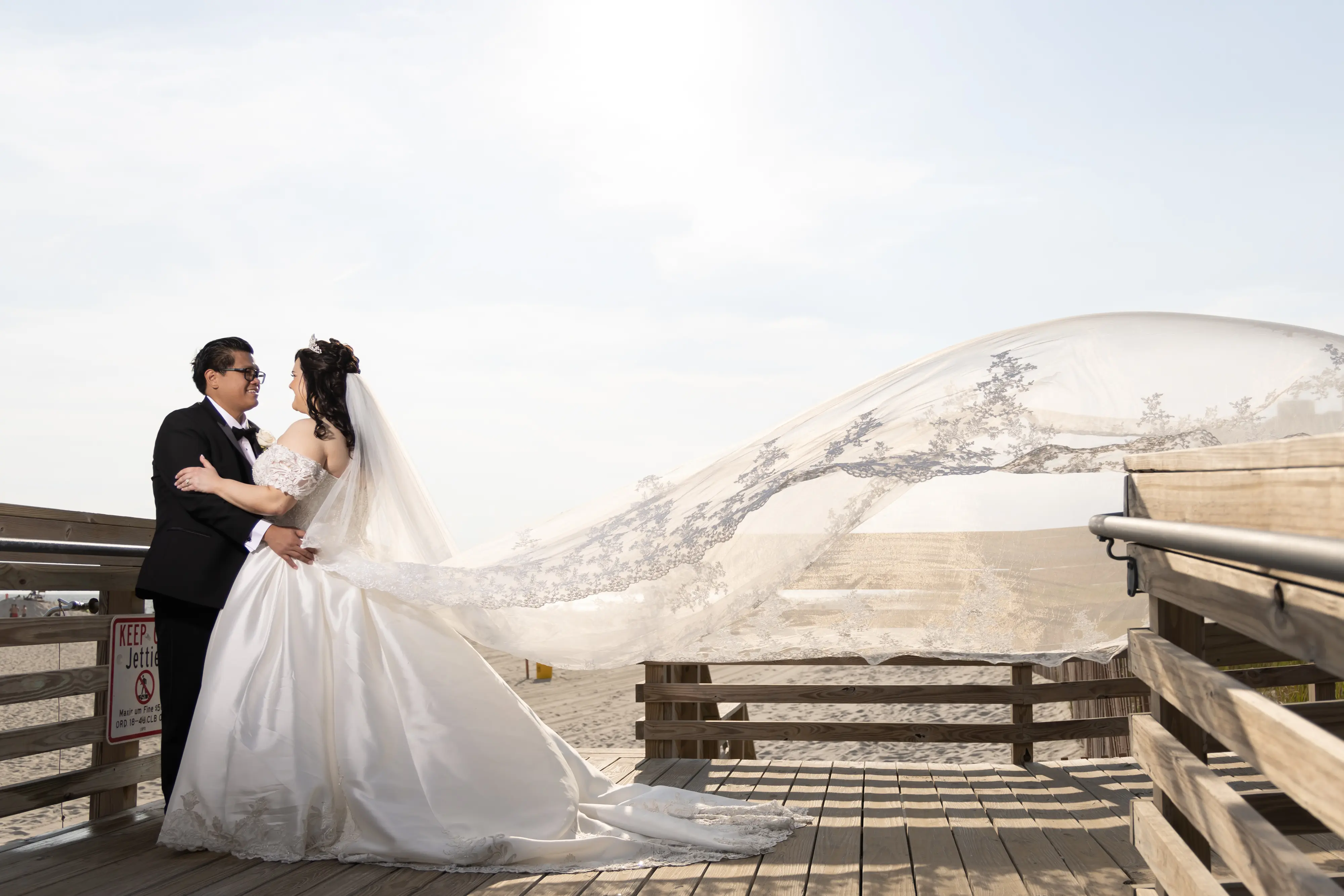 Groom Embracing Bride in Satin Ball Gown Wedding Dress Featuring Decadent Beaded Lace Bodice, Kimora by Sottero & Midgley with Beautiful Essex Vail.