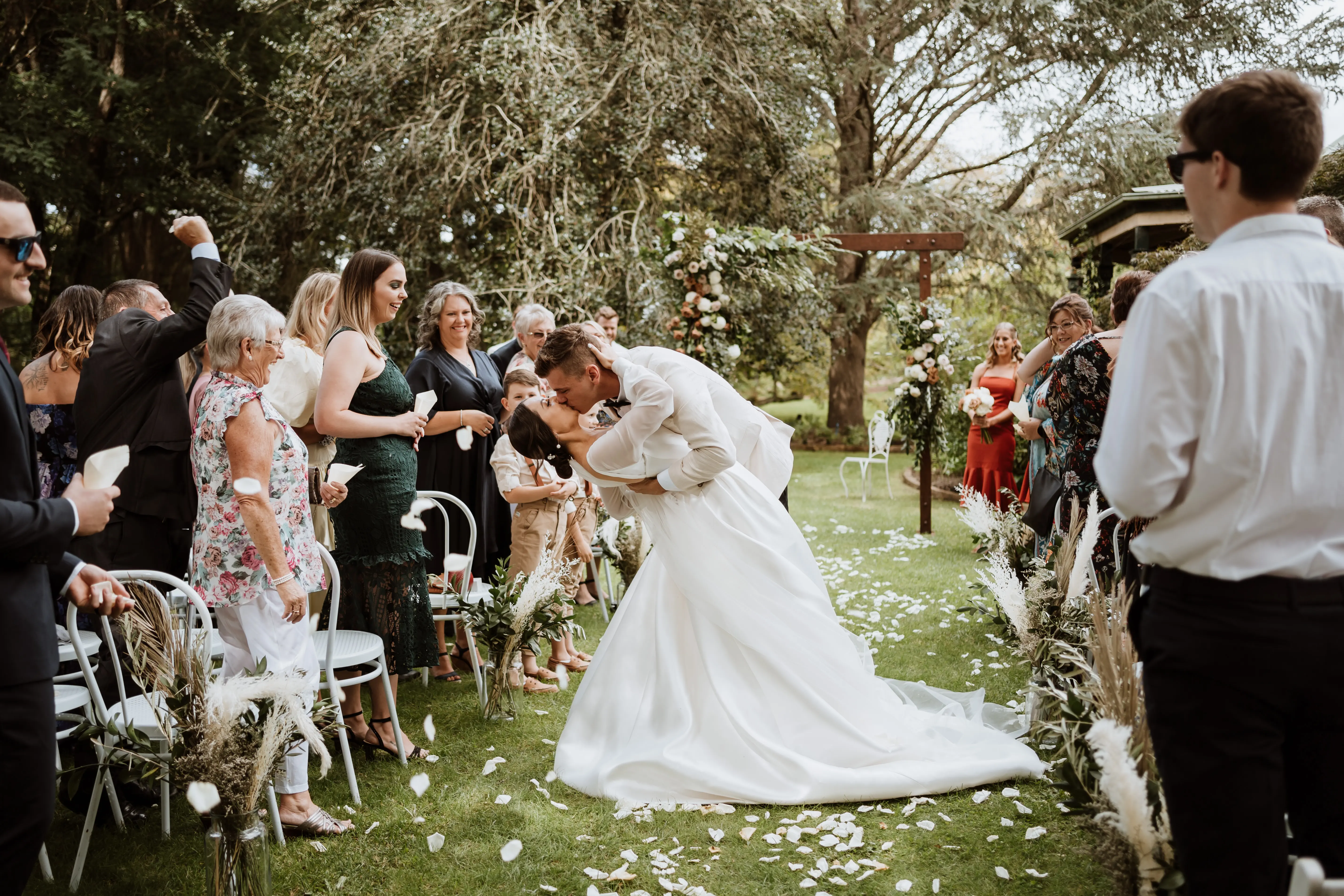 Groom dipping bride wearing wedding dress called Selena.