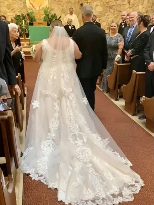 Bride wearing Lace A-line Wedding Dress called Trinity Lynette by Maggie Sottero walking down the aisle