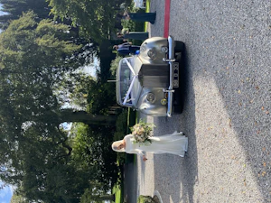 Bride Wearing Simple Crepe Wedding Dress Called Aston By Sottero And Midgley Next To A Vintage Car