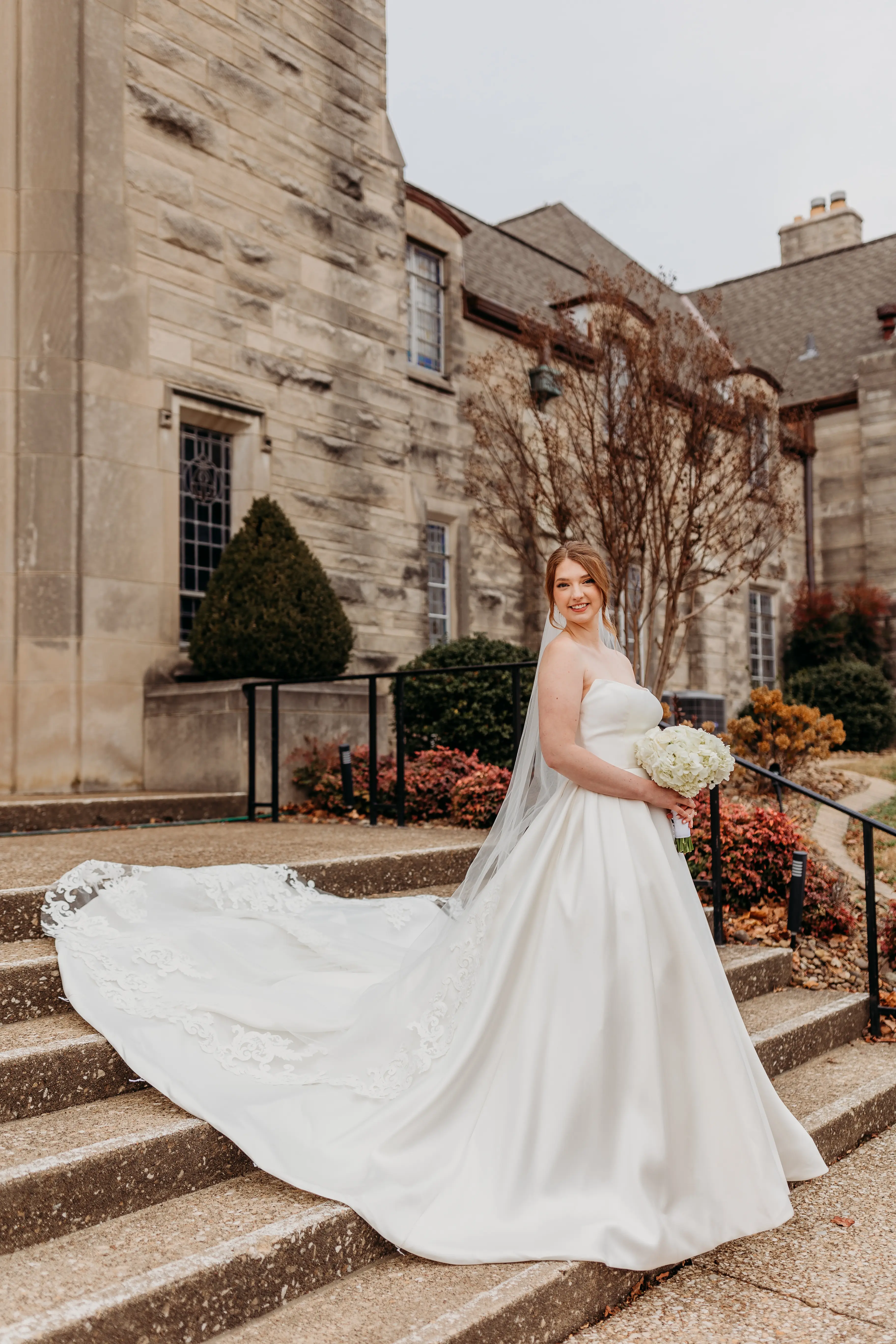 Real Bride Wearing A Strapless White Wedding Dress Named Selena By Maggie Sottero With Flowers