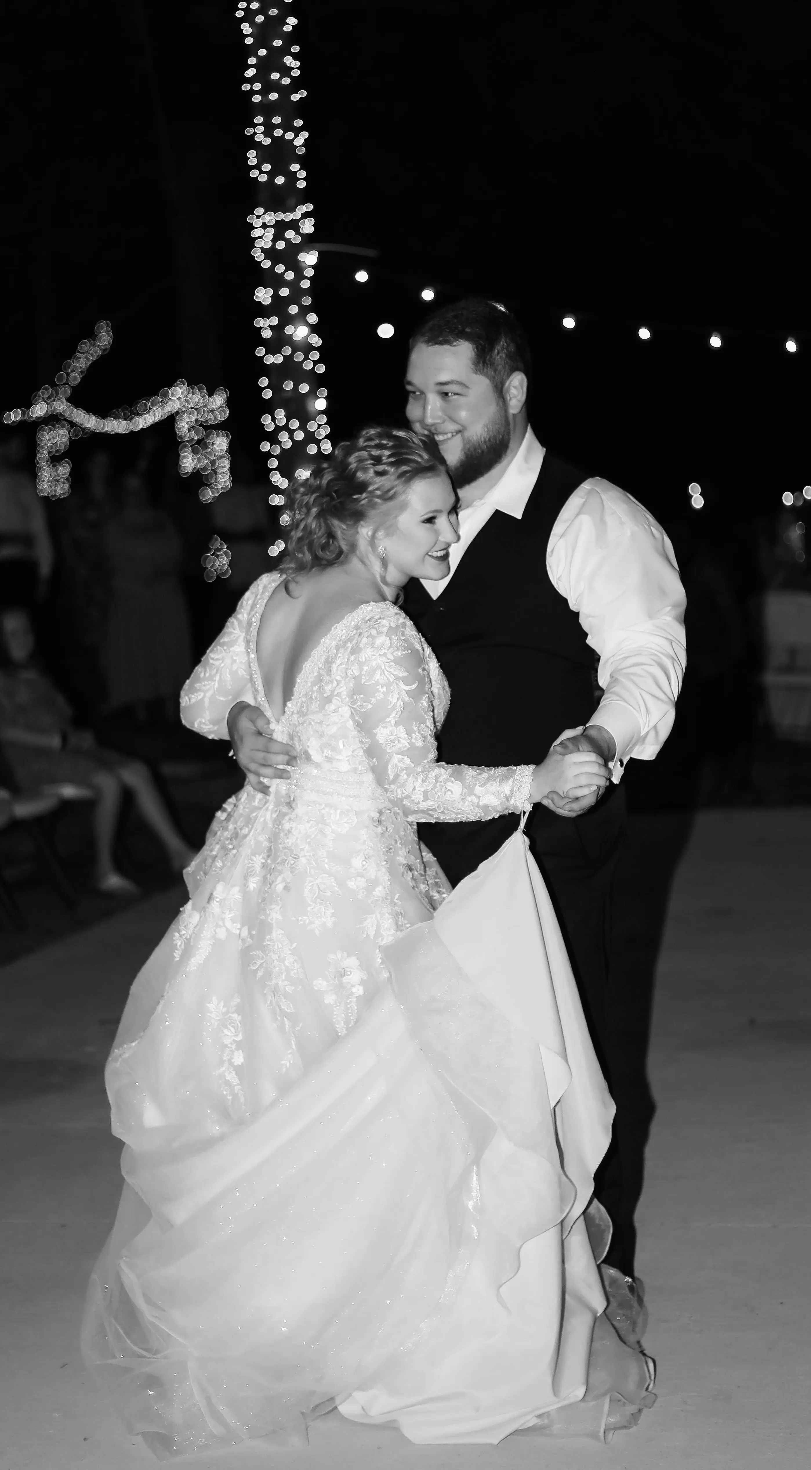 Bride And Groom Dancing Together. Bride Wearing Romantic A-Line Wedding Dress Called Raphael By Maggie Sottero