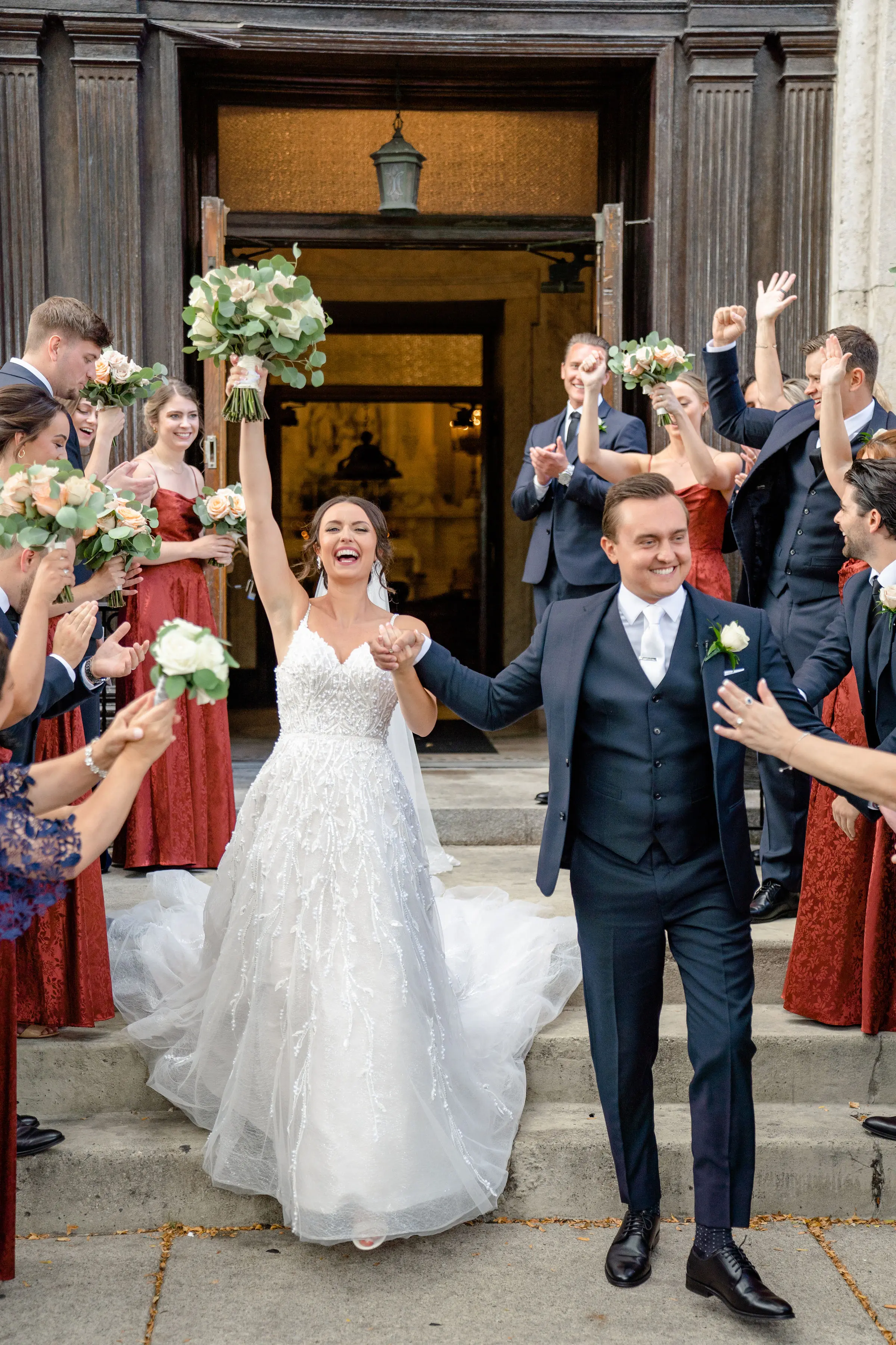 Bride wearing Marvine wedding gown by Sottero and Midgley exiting her ceremony with her husband