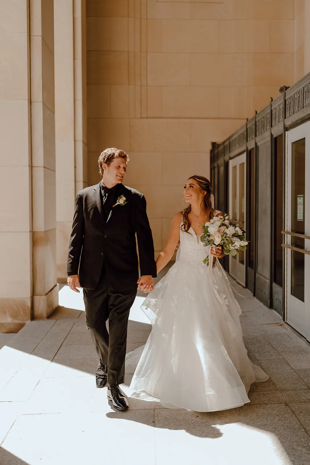 Bride Wearing Floral Ethereal Tulle Wedding Dress Called Lettie By Rebecca Ingram Holding Bouquet With Groom