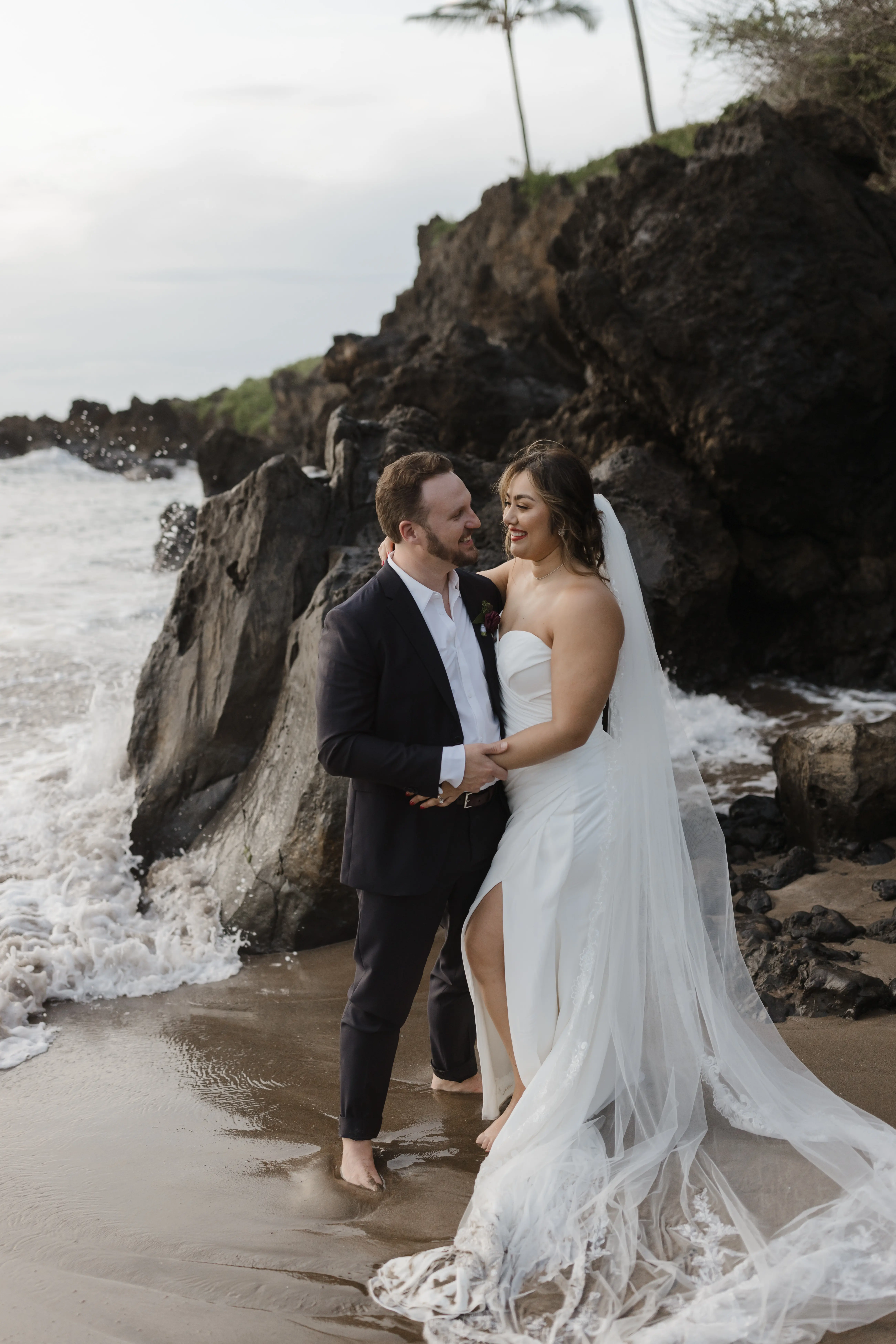 Bride On Beach With Groom In Strapless Wedding Dress Called Monaco By Maggie Sottero