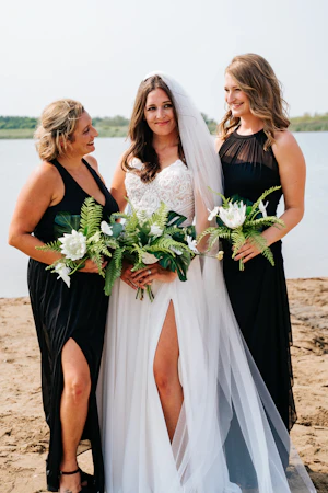 Bride Wearing Beach Sheath Wedding Dress Called Lorraine By Rebecca Ingram On The Beach With Her Bridesmaids