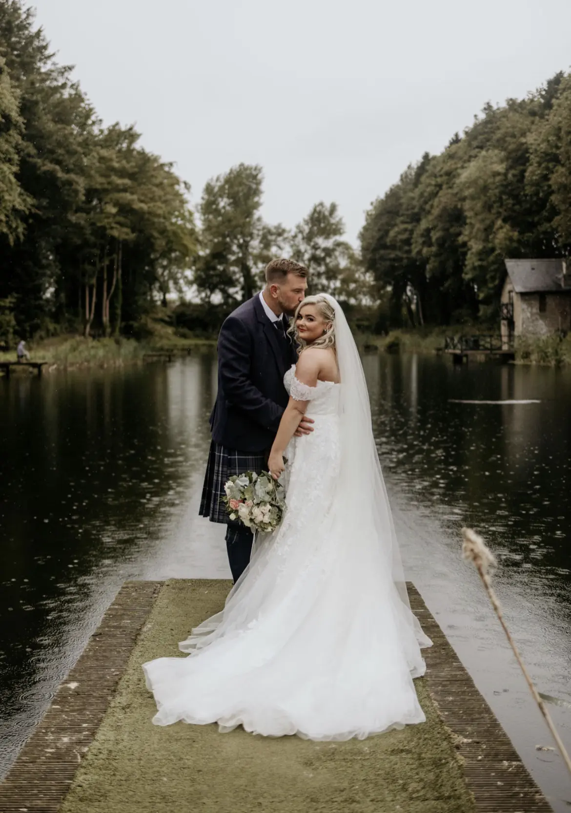 Bride wearing Rousseau wedding dress by Maggie Sottero with her groom