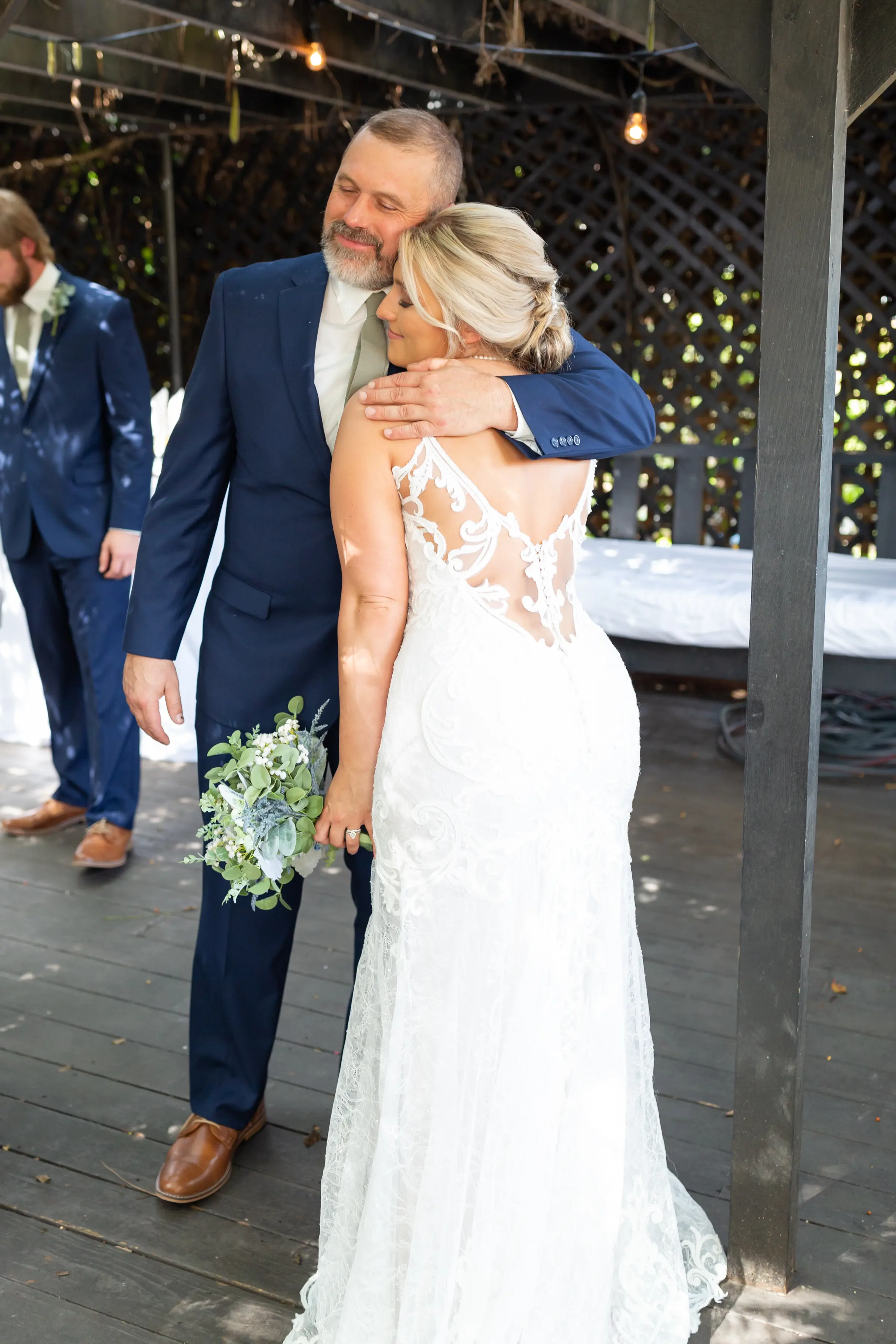 Sweet Father and the bride hugging.