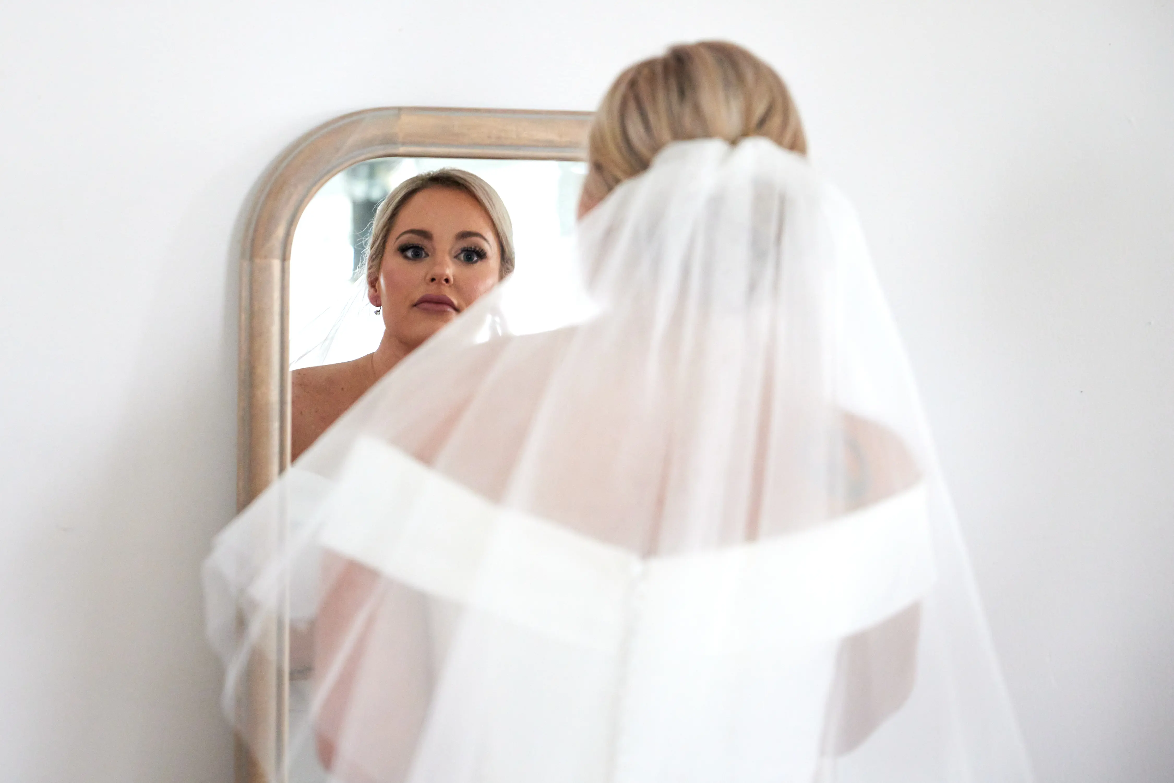 Bride Looking In Mirror Wearing Vintage Wedding Dress Called Josie by Rebecca Ingram.