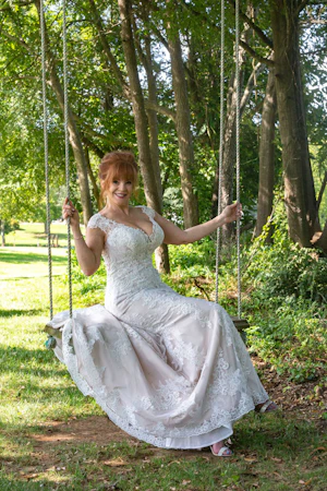 Bride on an Outdoor Swing Wearing a Lace Bridal Dress Called Daphne Lynette by Rebecca Ingram