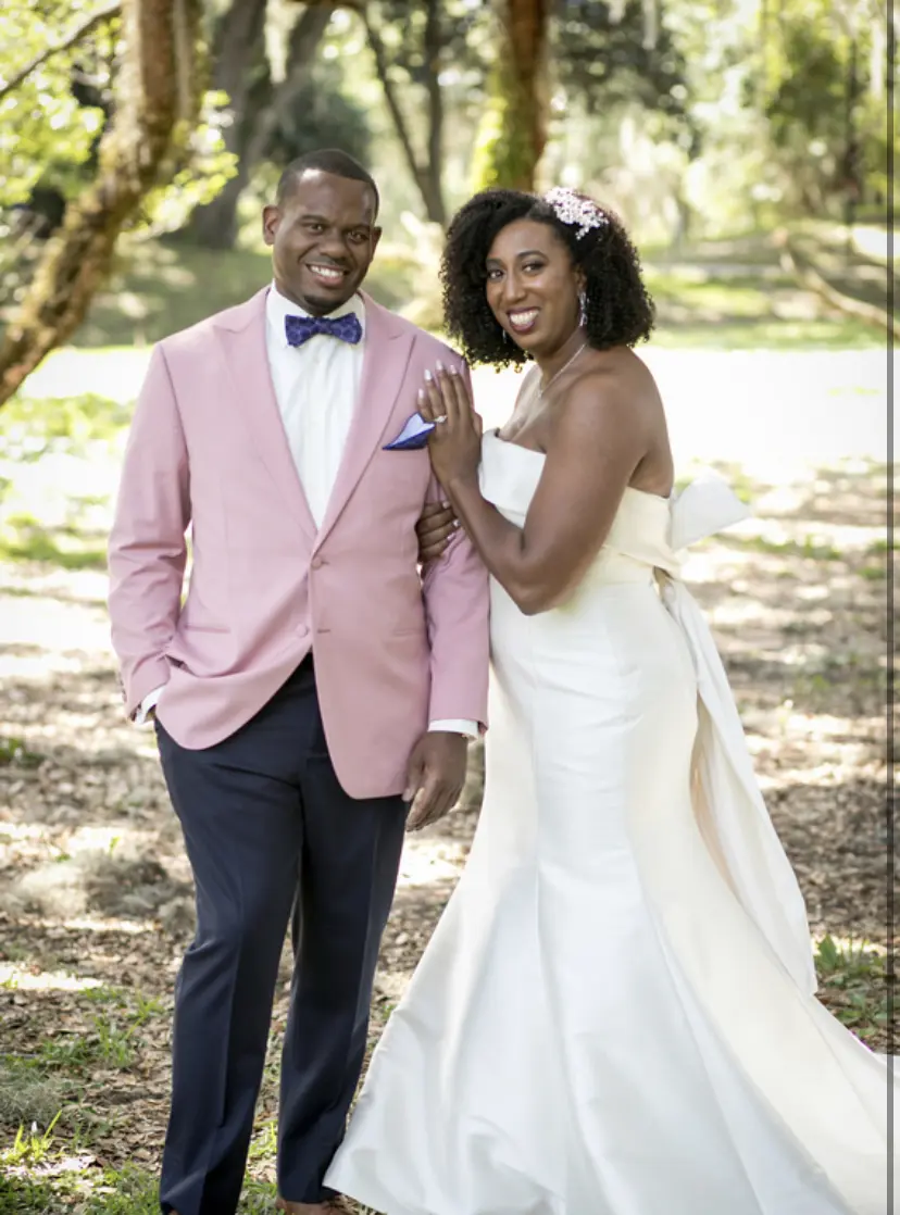Groom Posing With Bride In Strapless Satin Wedding Dress Named Mitchell By Maggie Sottero