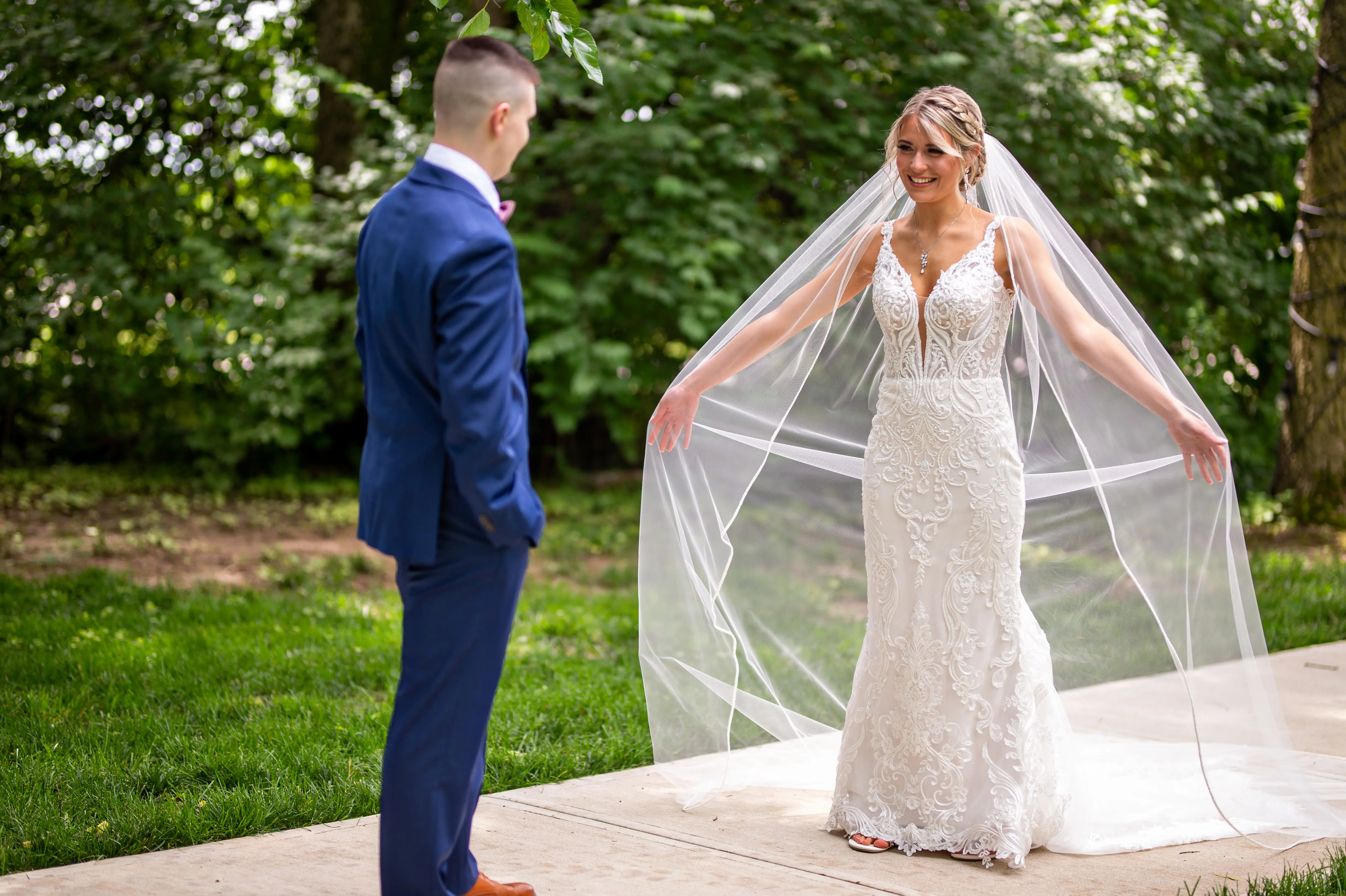 Groom with Bride in Elegant Lace Sheath Wedding Dress with Beaded Lace Motifs over Textured Tulle Called Hamilton by Sottero & Midgley