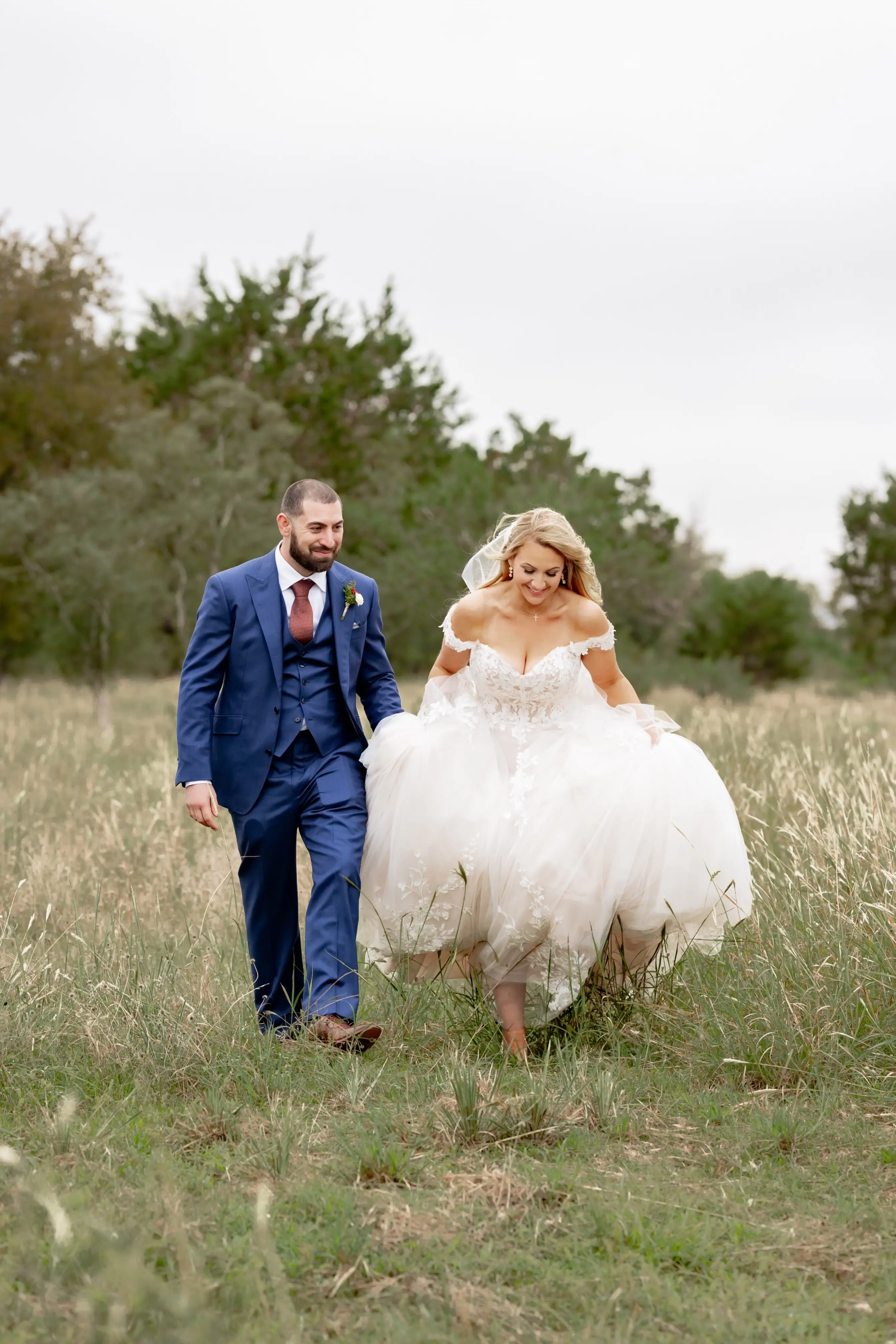 Bride wearing Harlem by Maggie Sottero walking with her husband