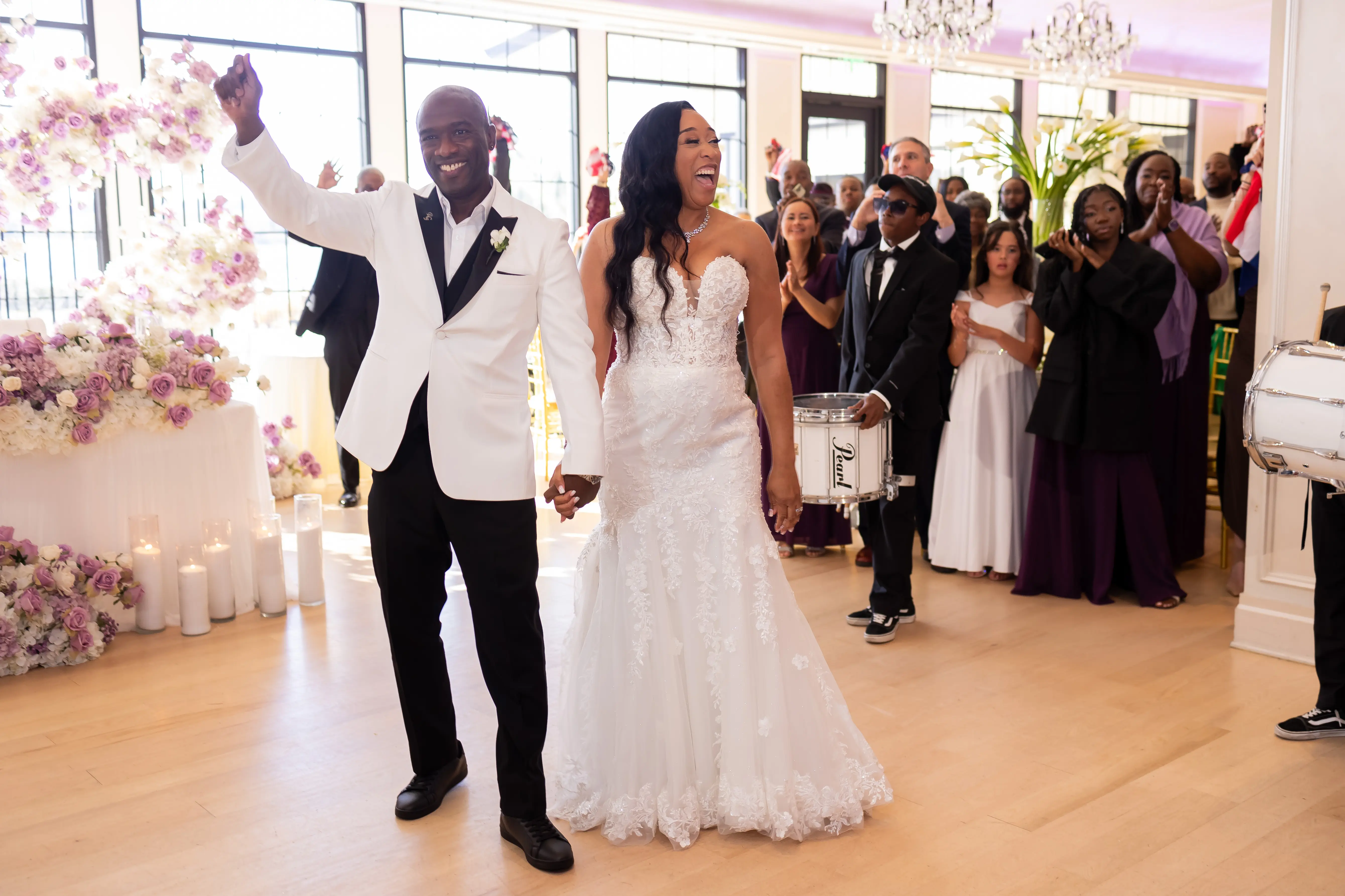 Bride Wearing Sexy Lace Wedding Dress Called Lennon By Maggie Sottero Holding Hands With Groom At The Reception