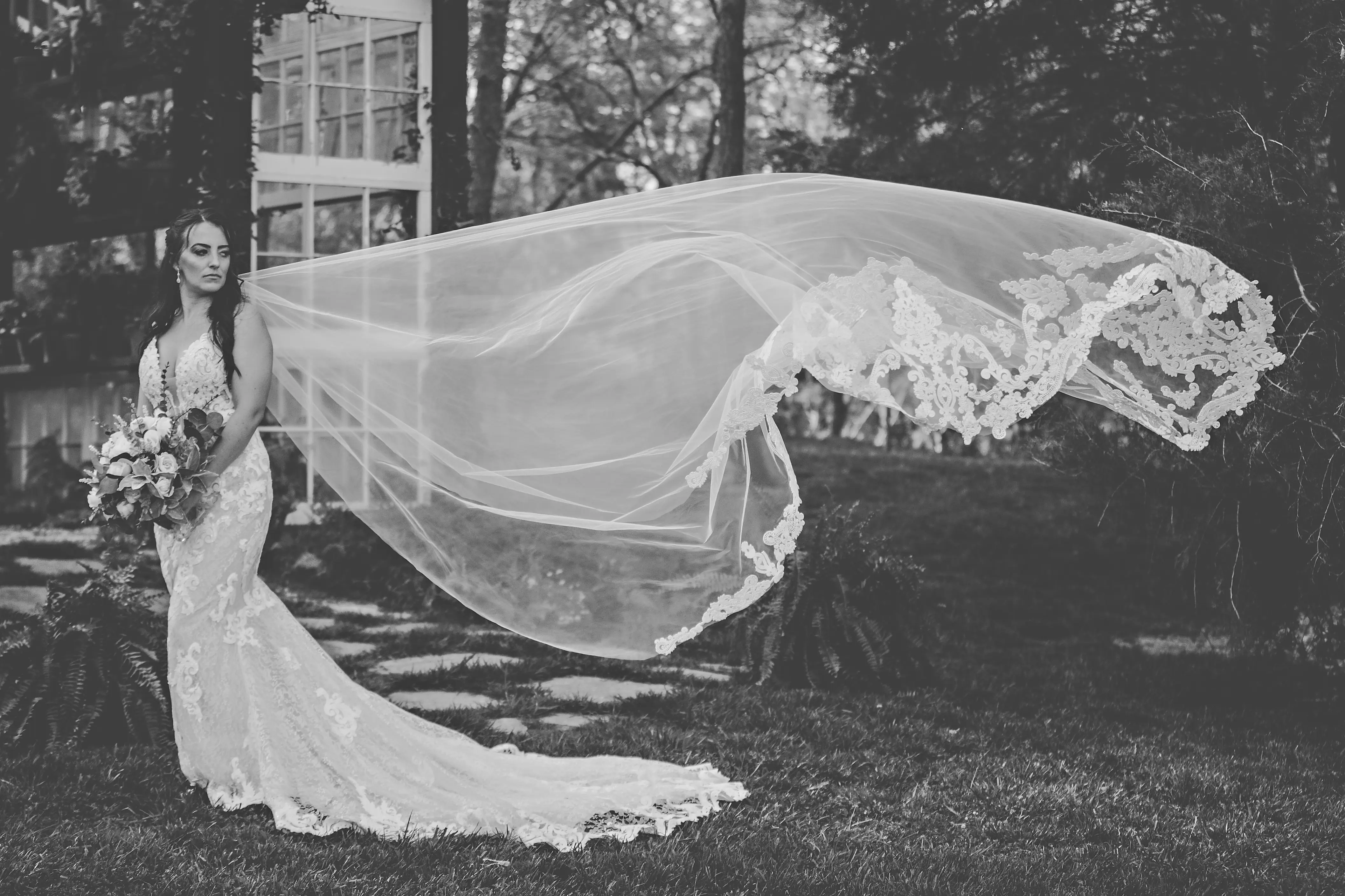 Bride in Romantic Lace Sheath Wedding Gown with Tulle Veil Edge in Sequined Lace Motifs called Tuscany Lynette by Maggie Sottero