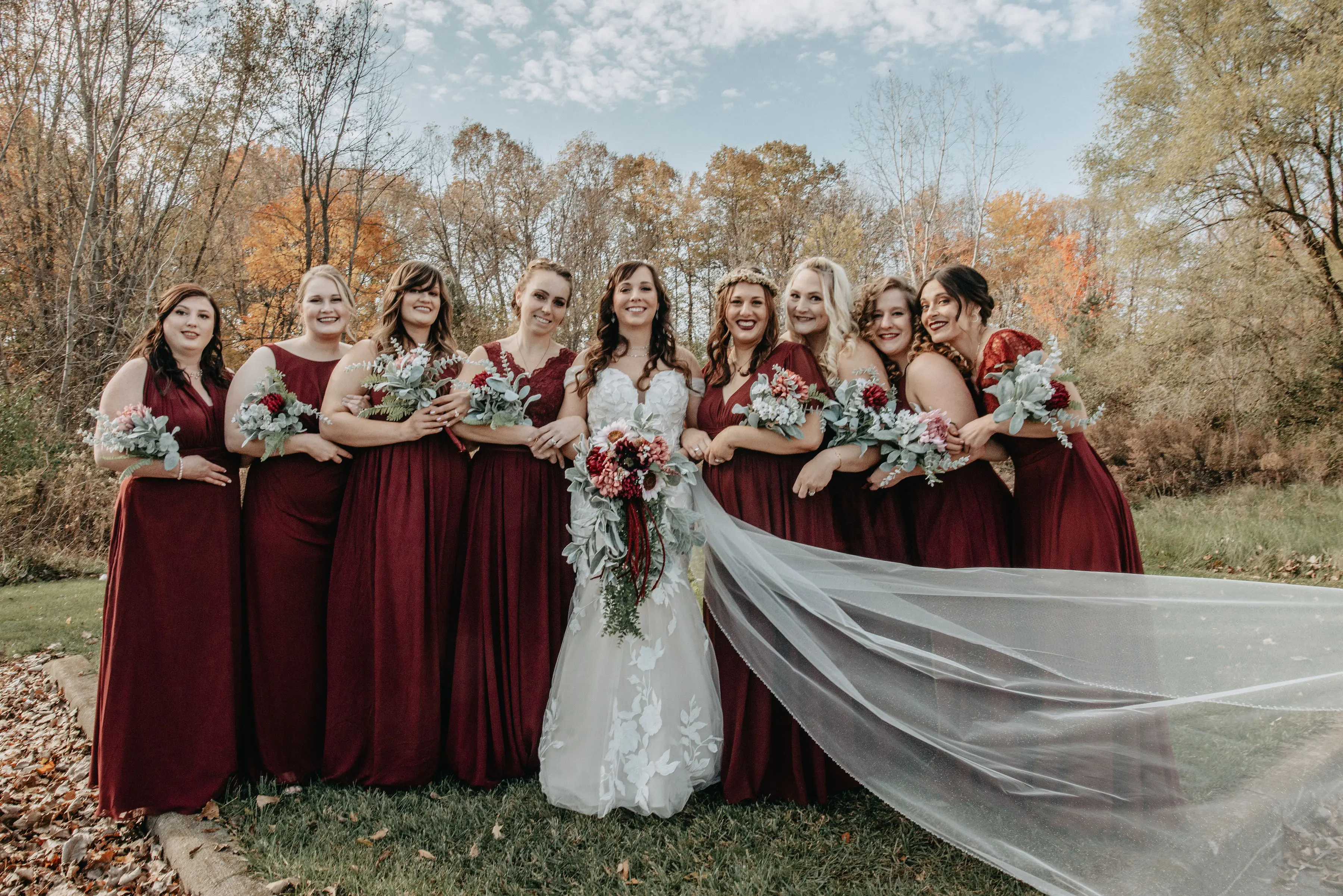 Bride wearing Mermaid Lace wedding dress called Hattie by Rebecca Ingram with her bridesmaids