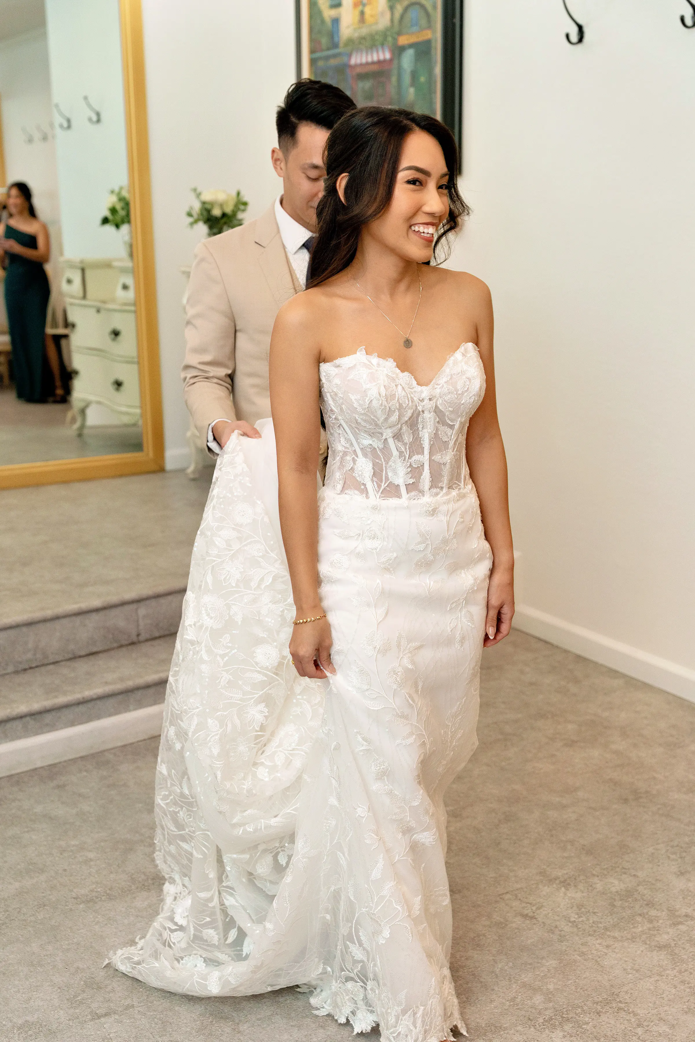 Bride Wearing Lace Fit And Flare Wedding Dress Called Fairchild By Maggie Sottero With Groom Holding Her Train