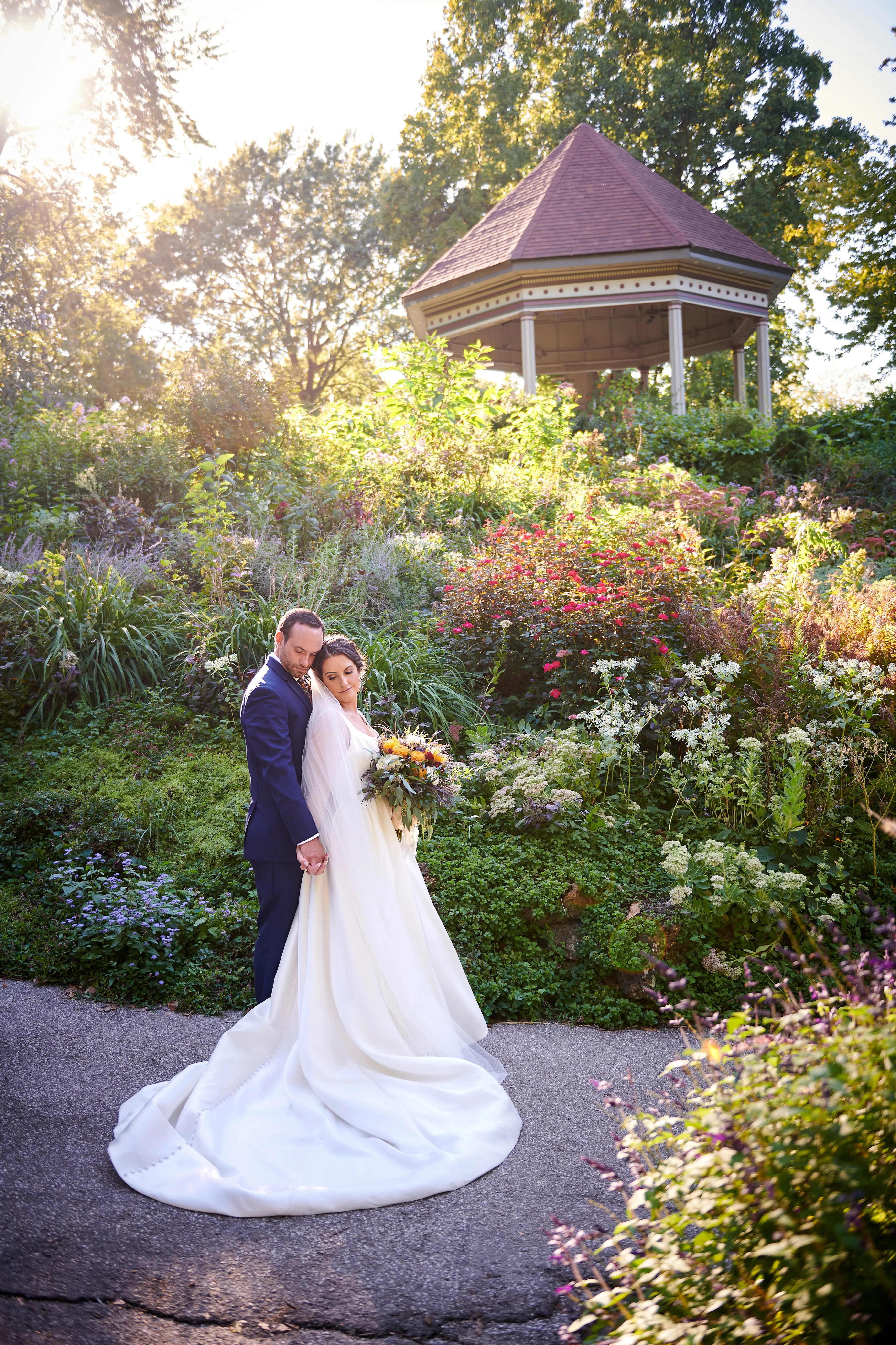 Bride Wearing Classic A-Line Bridal Gown Called Selena By Maggie Sottero With Groom In A Garden