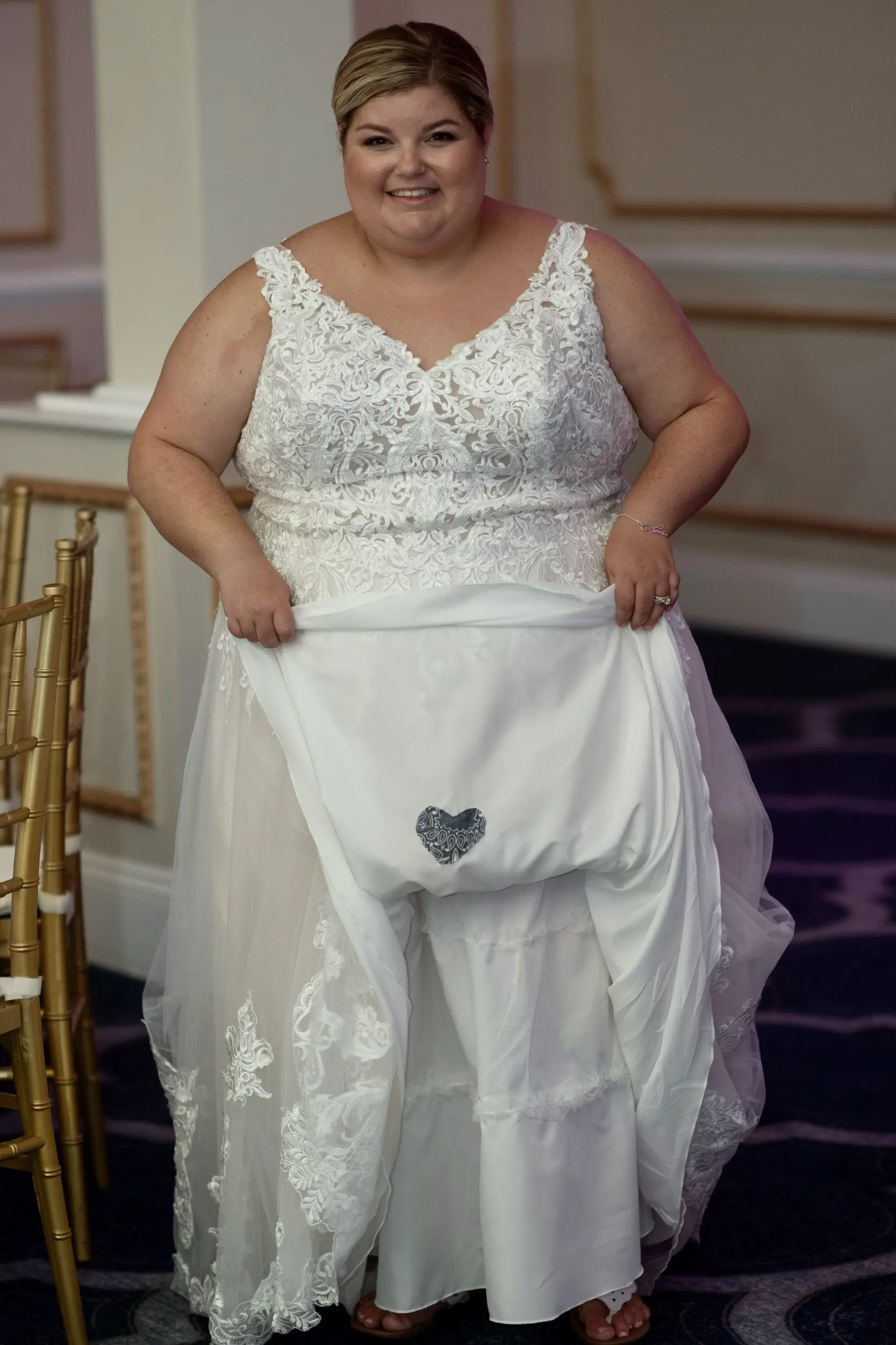 Bride showing her something blue attached to her Lace A-line Wedding Dress called Trinity Lynette by Maggie Sottero