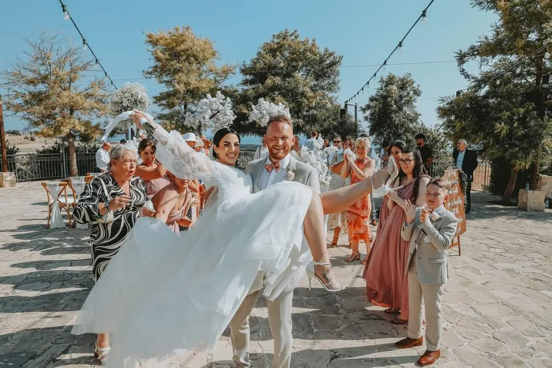 Bride Wearing Boho A-Line Wedding Dress Called Nerida By Sottero And Midgley With Groom Holding Her