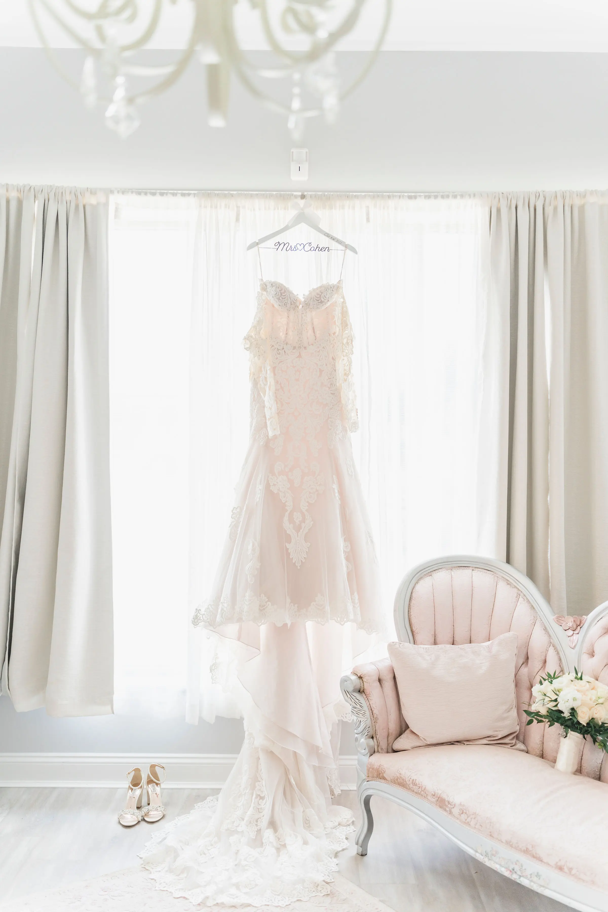 Sparkly Lace Fit-and-Flare Wedding Dress Hanging Up Indoors.
