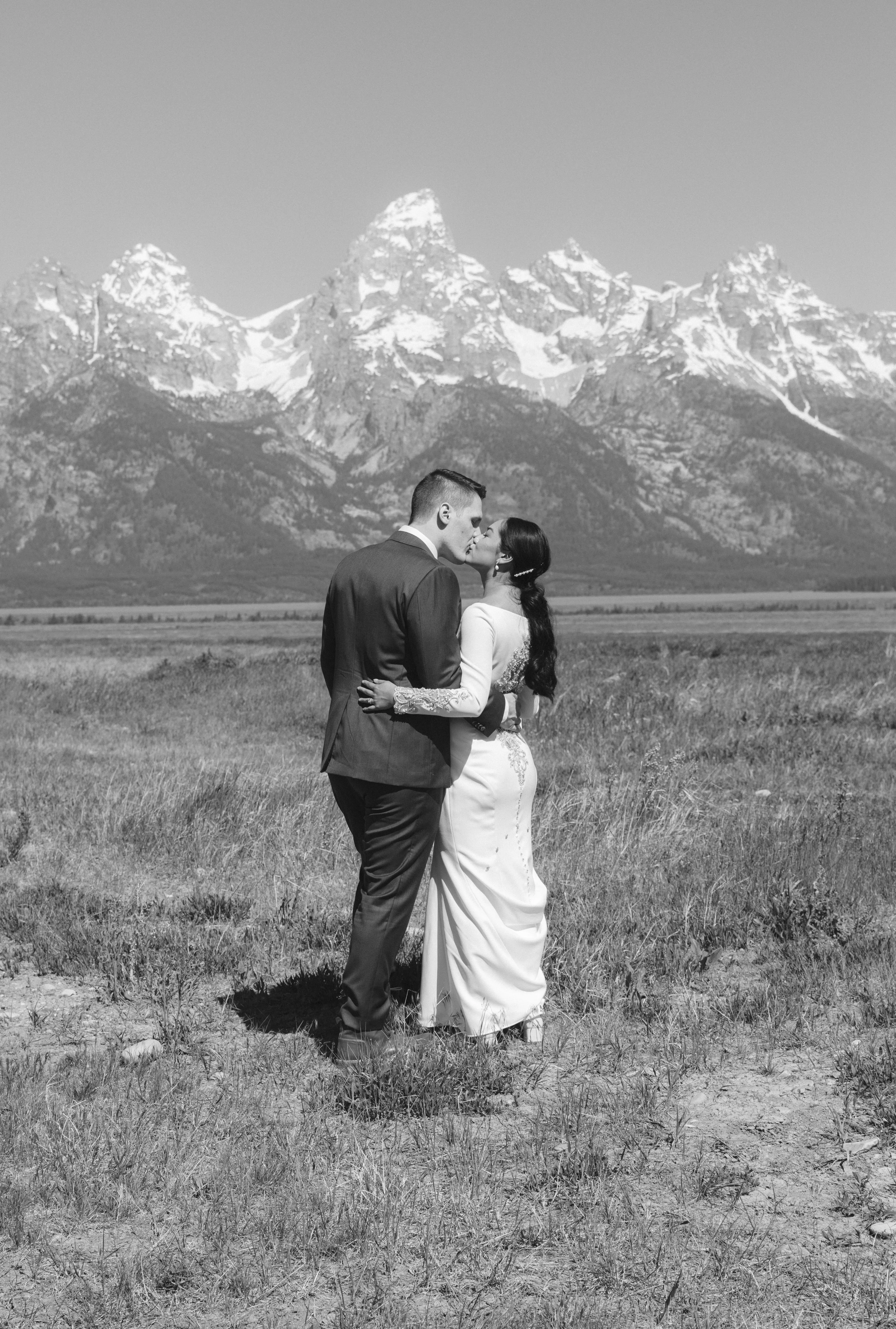 Bride wearing Aston by Sottero and Midgley kissing her husband