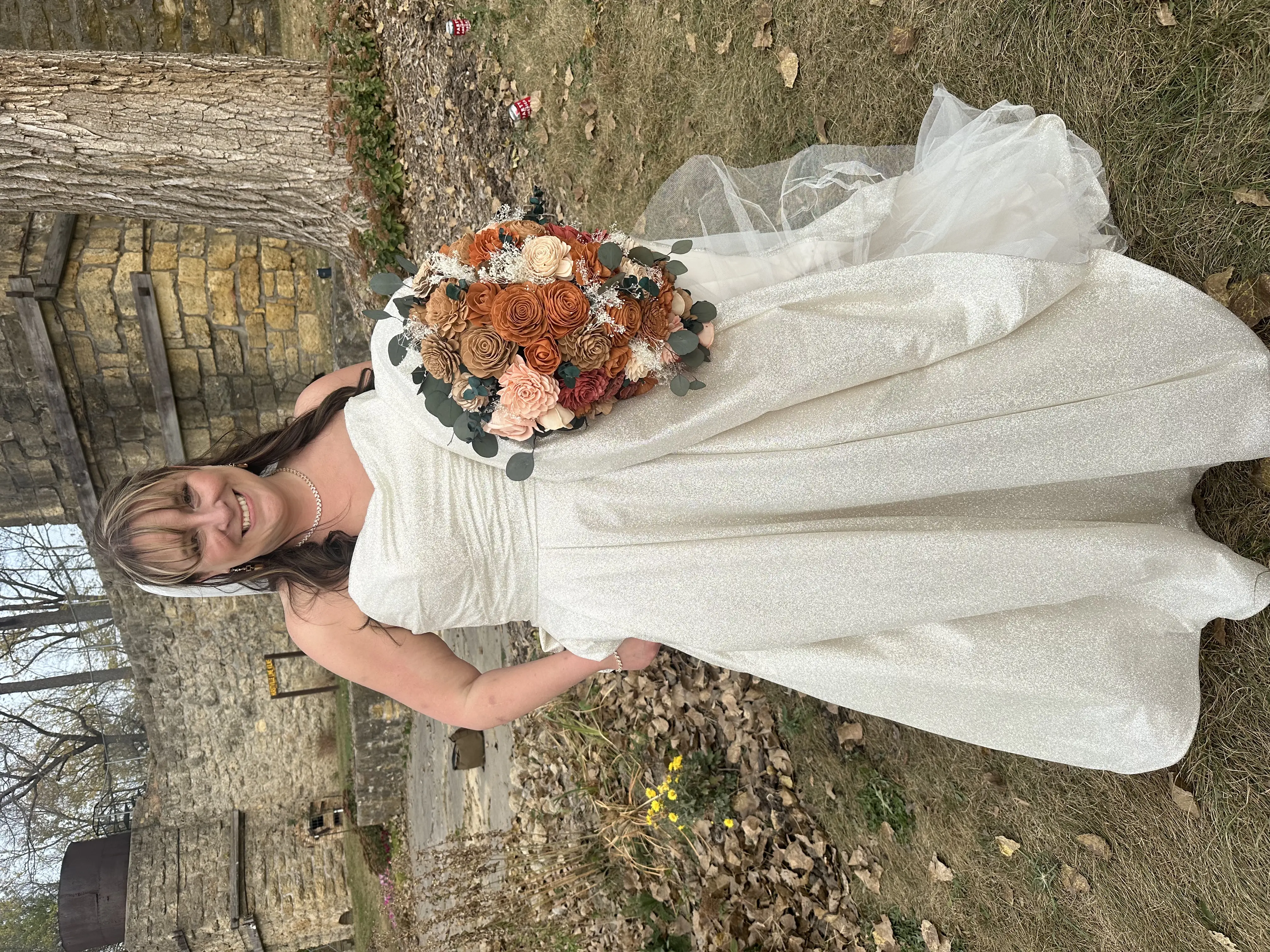 Bride Wearing Sparkly Aline Wedding Dress Called Anniston By Maggie Sottero Holding A Fall Themed Rose Bouquet