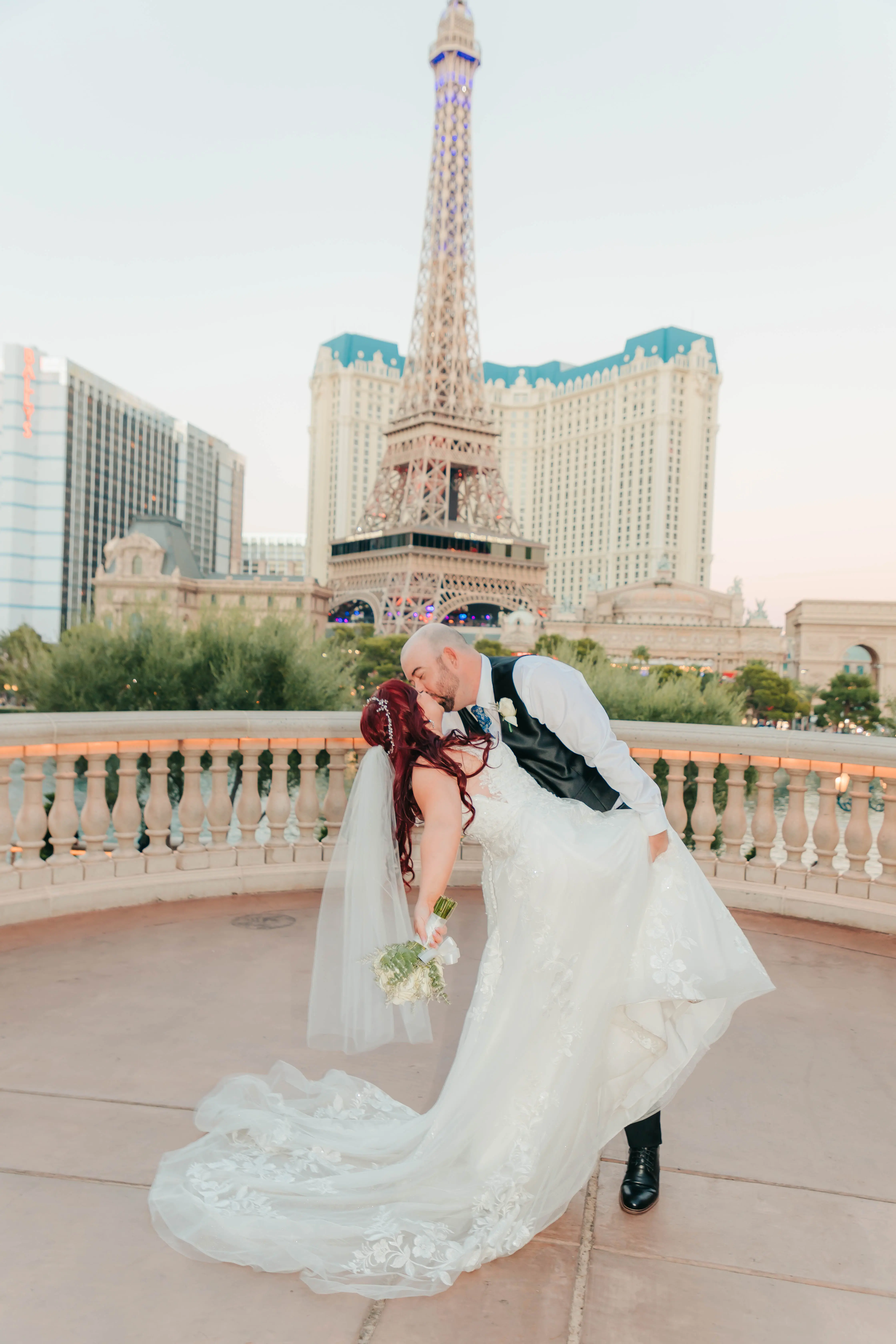 Groom and Bride Kissing at a Las Vegas Wedding Wearing Lace Ballgown Called Ellen by Rebecca Ingram
