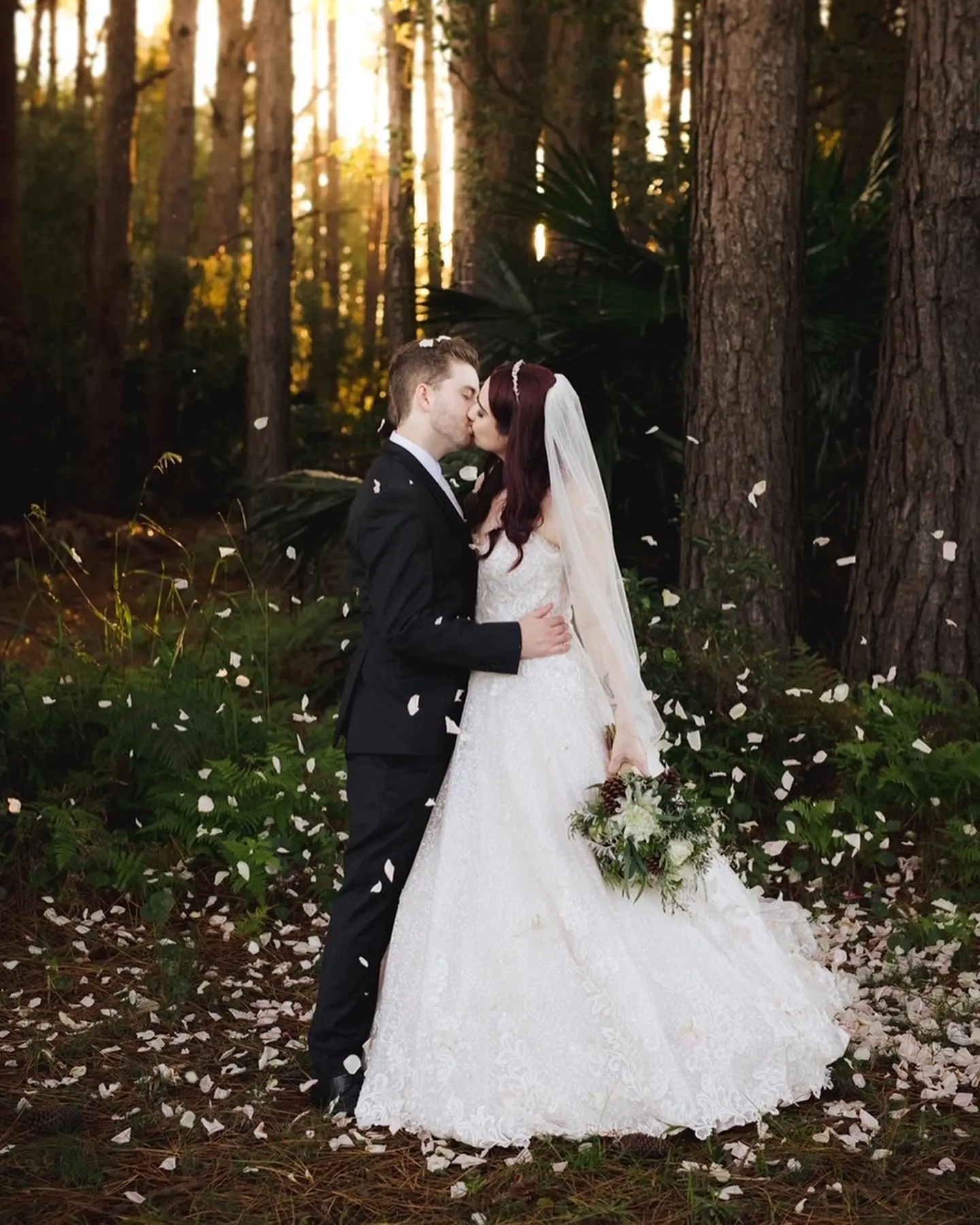 Groom Kissing Bride in Lace Ball Gown Wedding Dress with Sequined Tulle and Lace Motifs over Bodice and Statement Hemline called Tristyn by Maggie Sottero