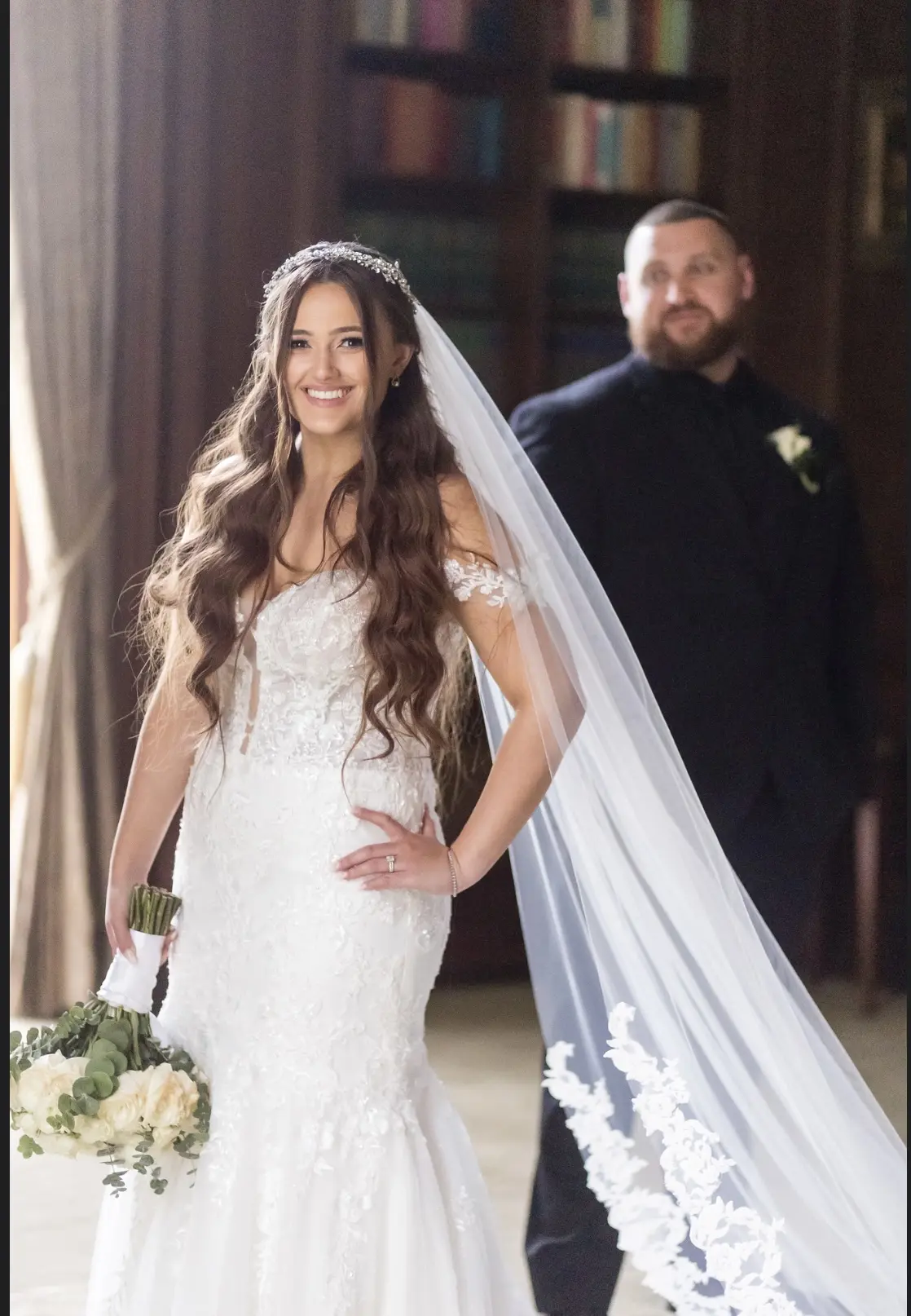 Bride wearing Lennon wedding dress by Maggie Sottero in front of her husband