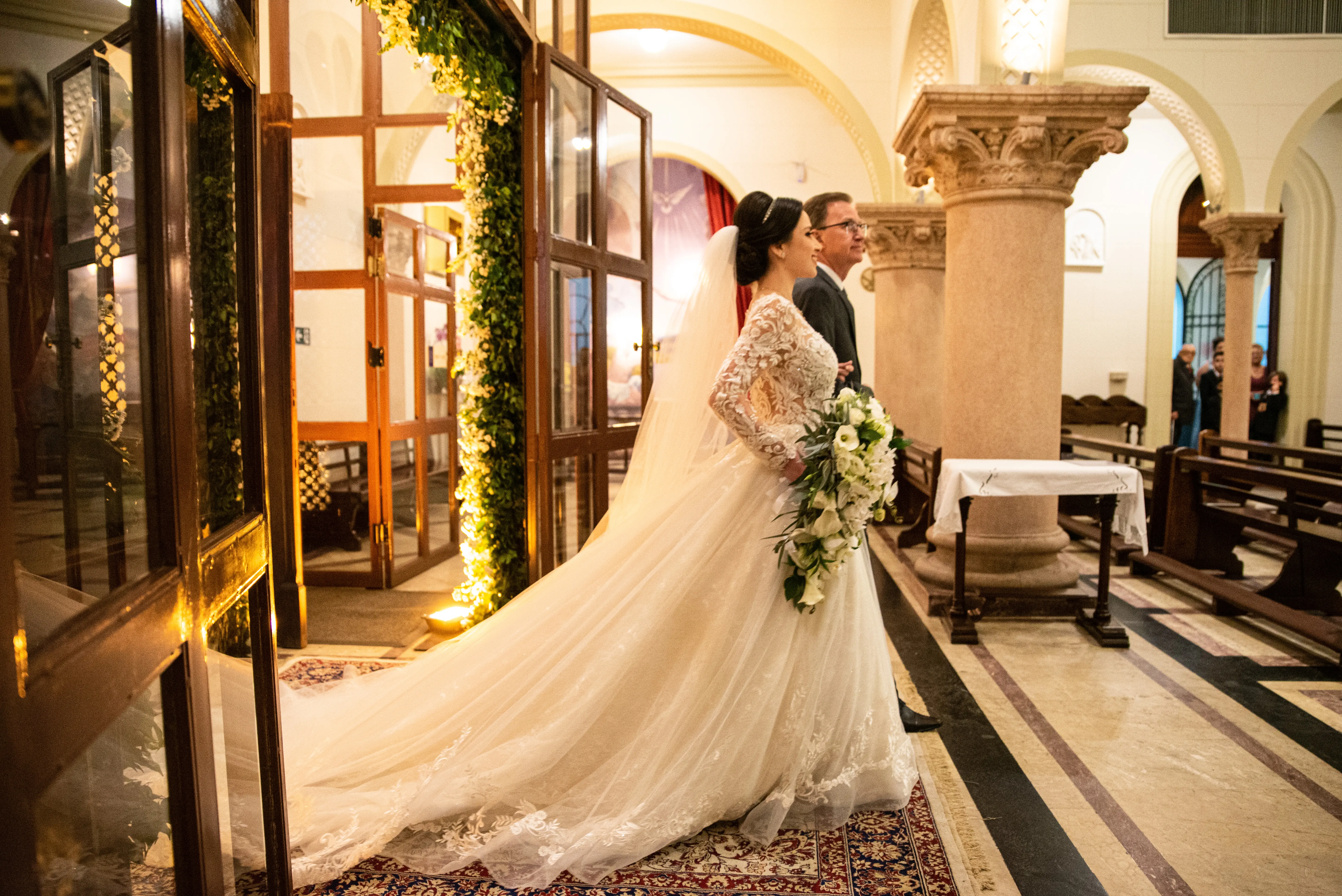 Bride Smiling While Wearing Lace A-Line Wedding Dress Called Zander By Sottero And Midgley Walking Down The Aisle