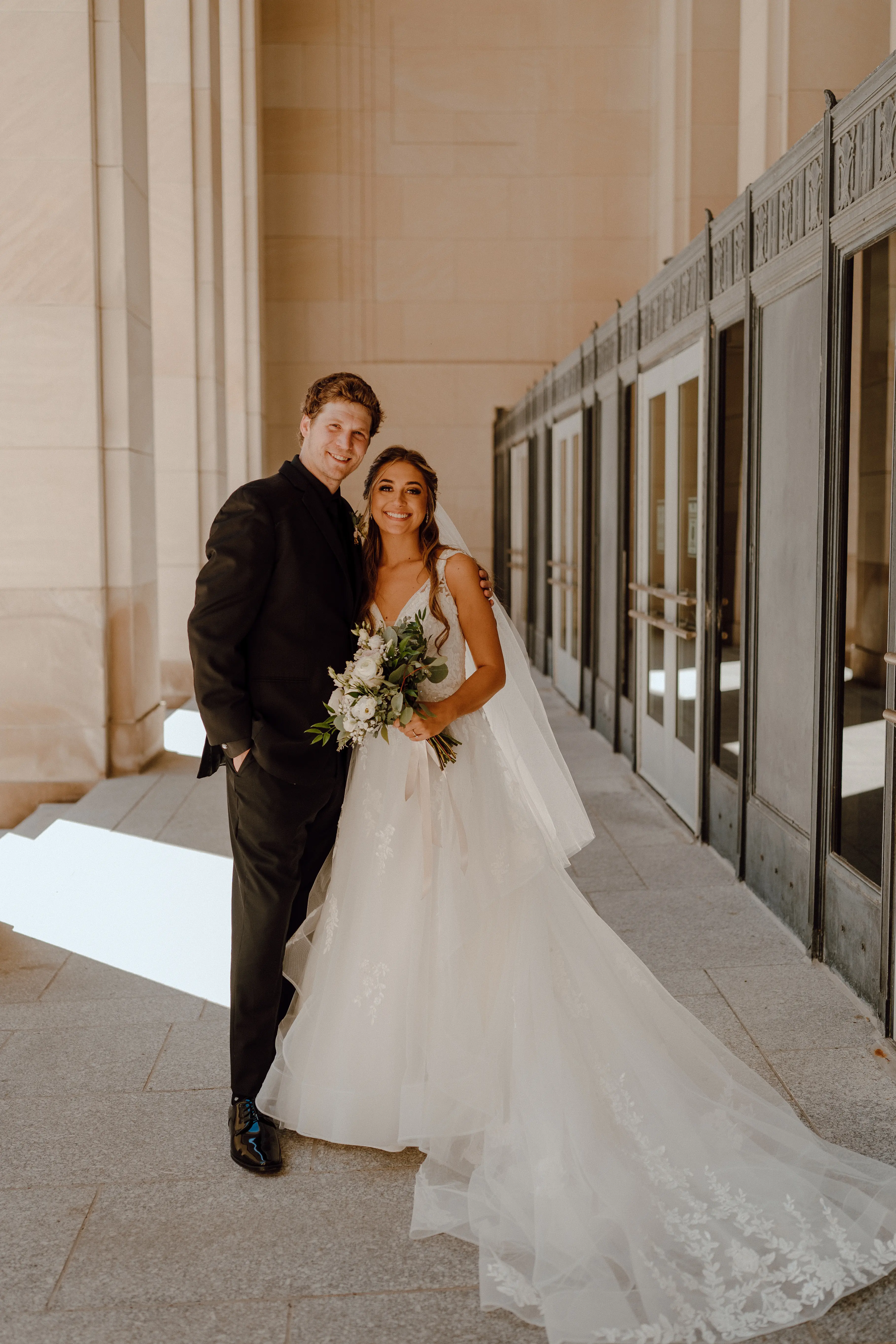 Bride in ruffle dress with illusion bodice called Lettie by Rebecca Ingram with groom